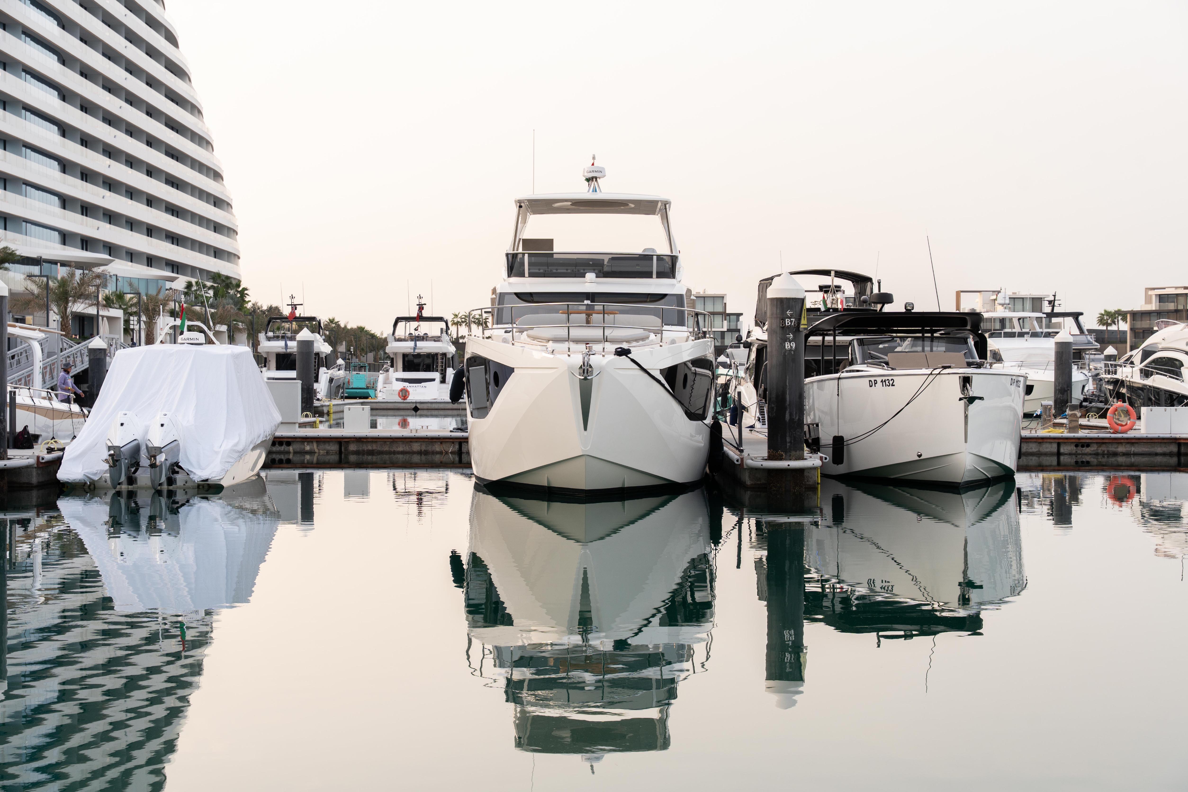 Luxury yachts docked at marina, featuring 2025 Absolute 52 FLY model.