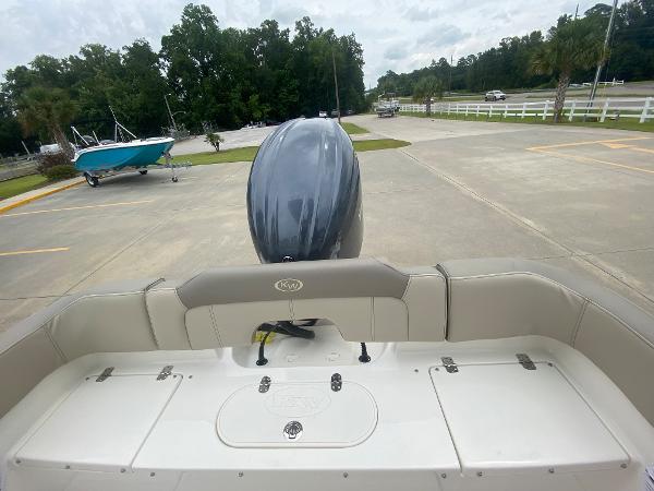 2024 Key West 203 FS boat with outboard motor in parking lot.