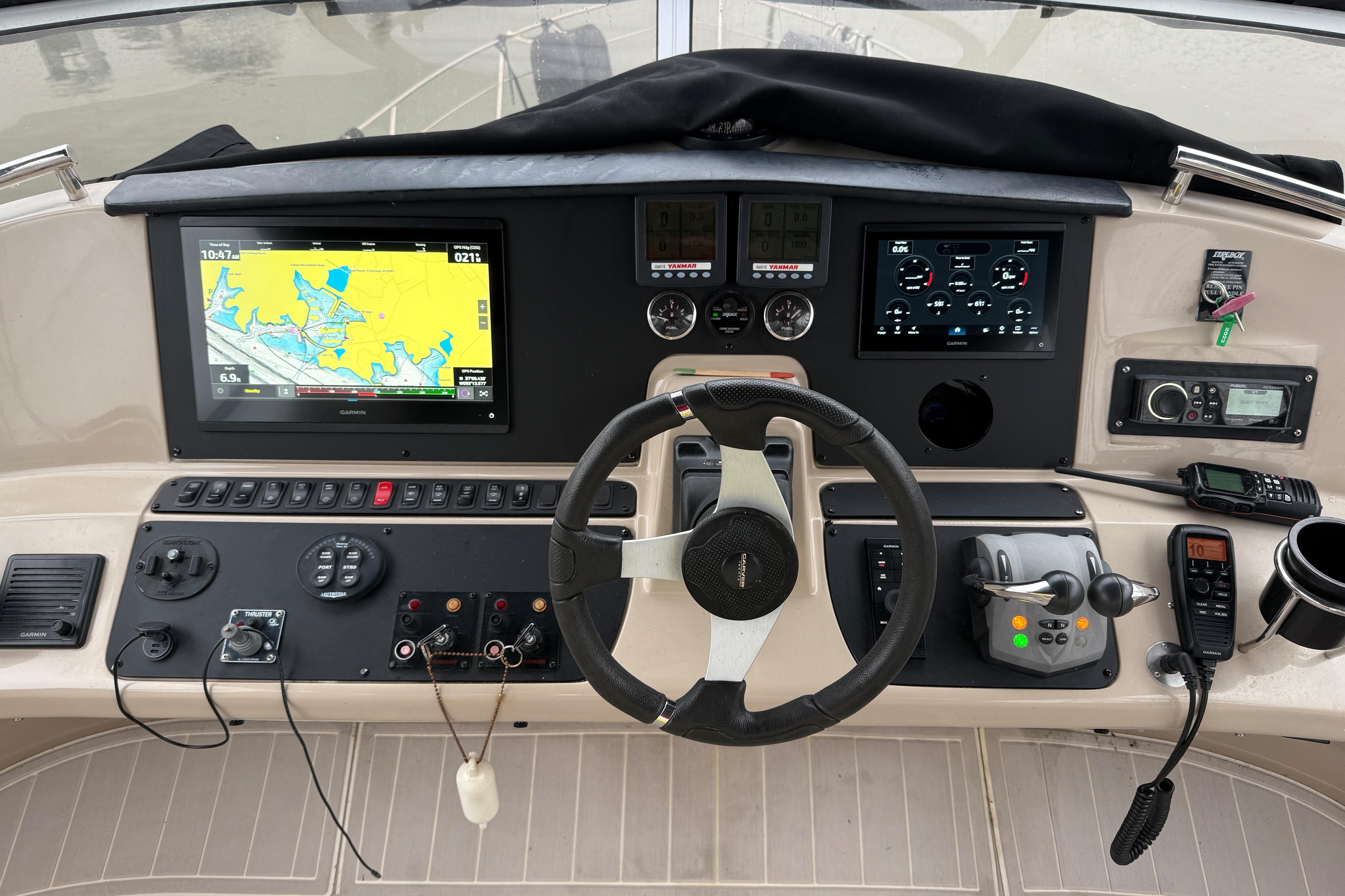 Helm of 2006 Carver 43 Motor Yacht with navigation screens and controls.