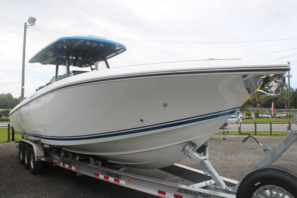 2024 Fountain 34 SC boat on trailer, side view, outdoors.