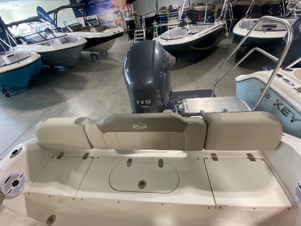 2024 Key West 189 FS boat interior with Yamaha 115 outboard motor in showroom.
