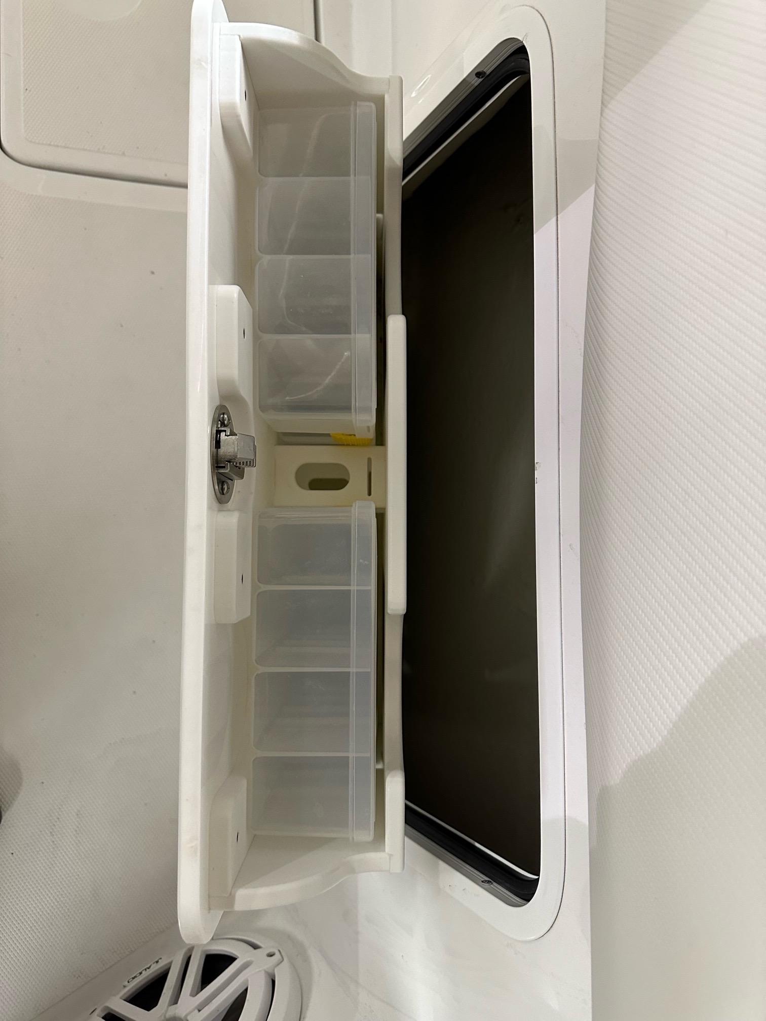 2021 Wellcraft 262 Fisherman tackle storage compartment with organized slots.