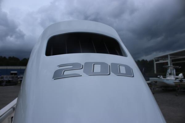 2025 Carolina Skiff 23 LS boat engine with "200" marking under cloudy sky.