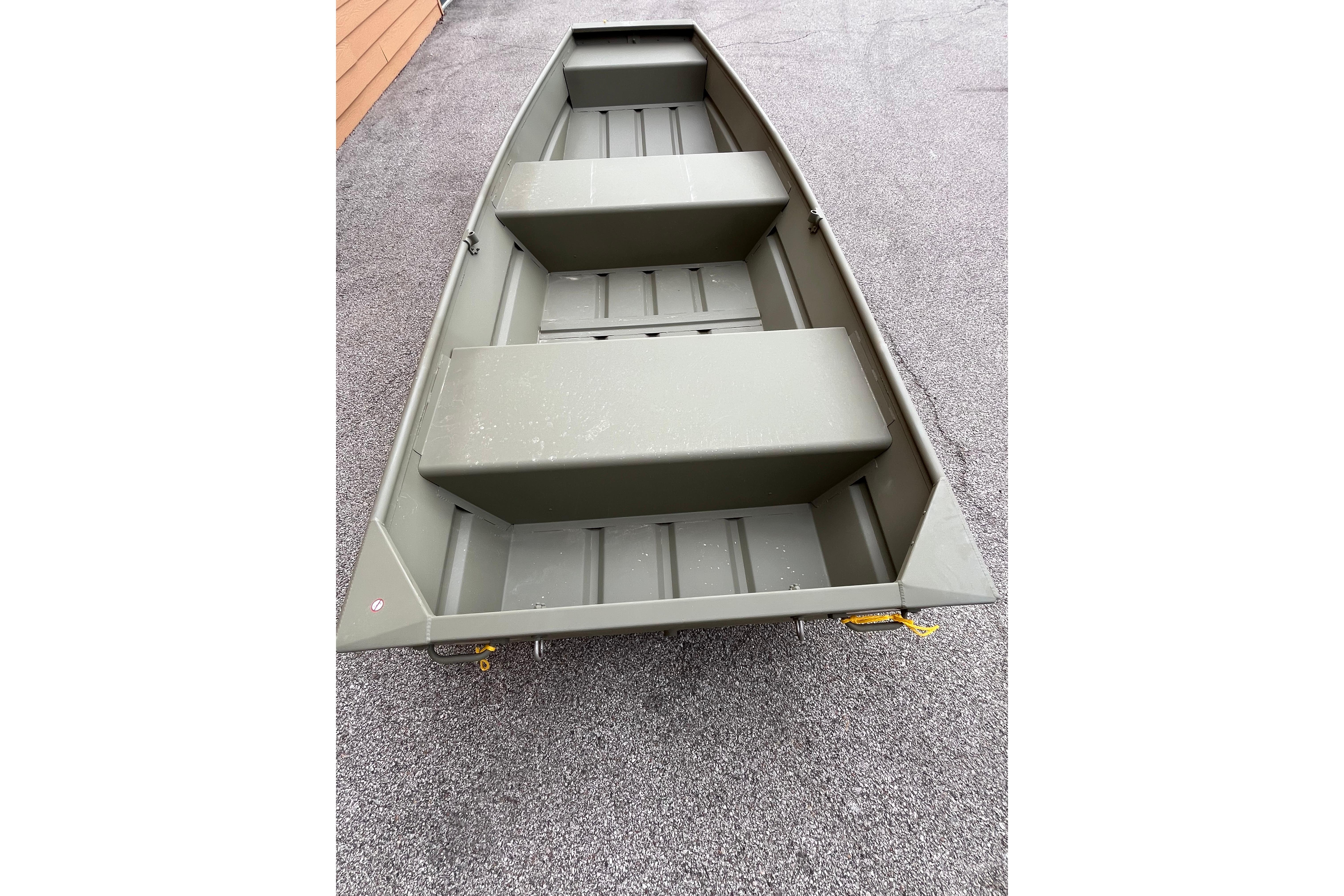 2026 Tracker Grizzly 12 Jon boat on pavement, showcasing its sturdy design.