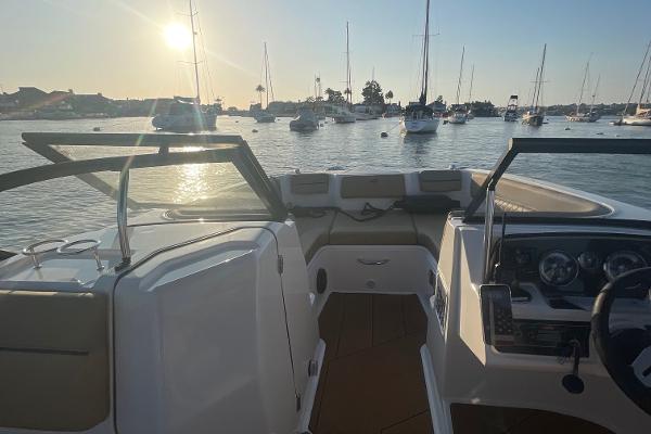 2024 Bayliner DX 2250 boat interior with scenic marina view at sunset.
