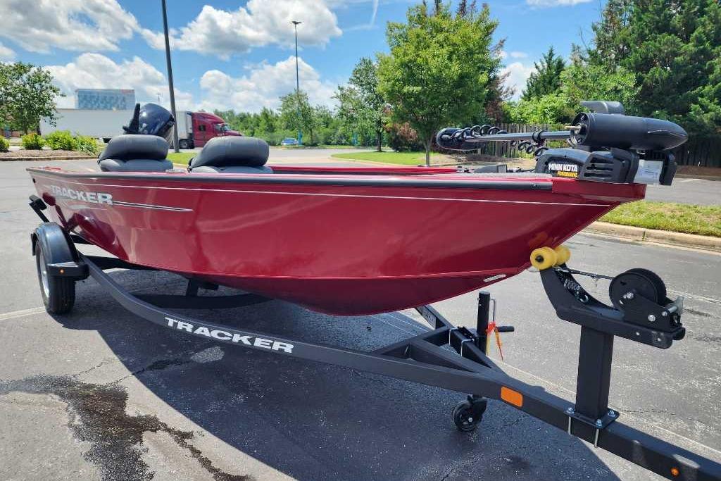 2025 Tracker Super Guide V-16 T boat on trailer, red exterior, parked outdoors.