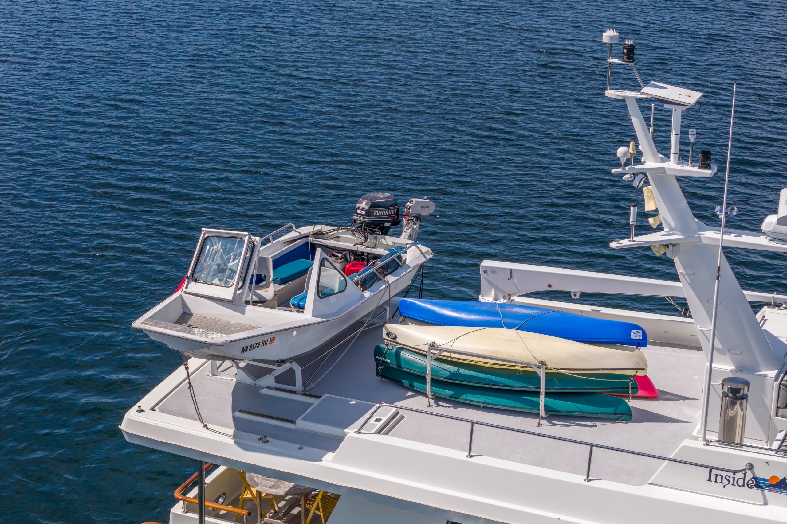 1991 Forbes Cooper Pilothouse Motoryacht with small boat and kayaks on deck.