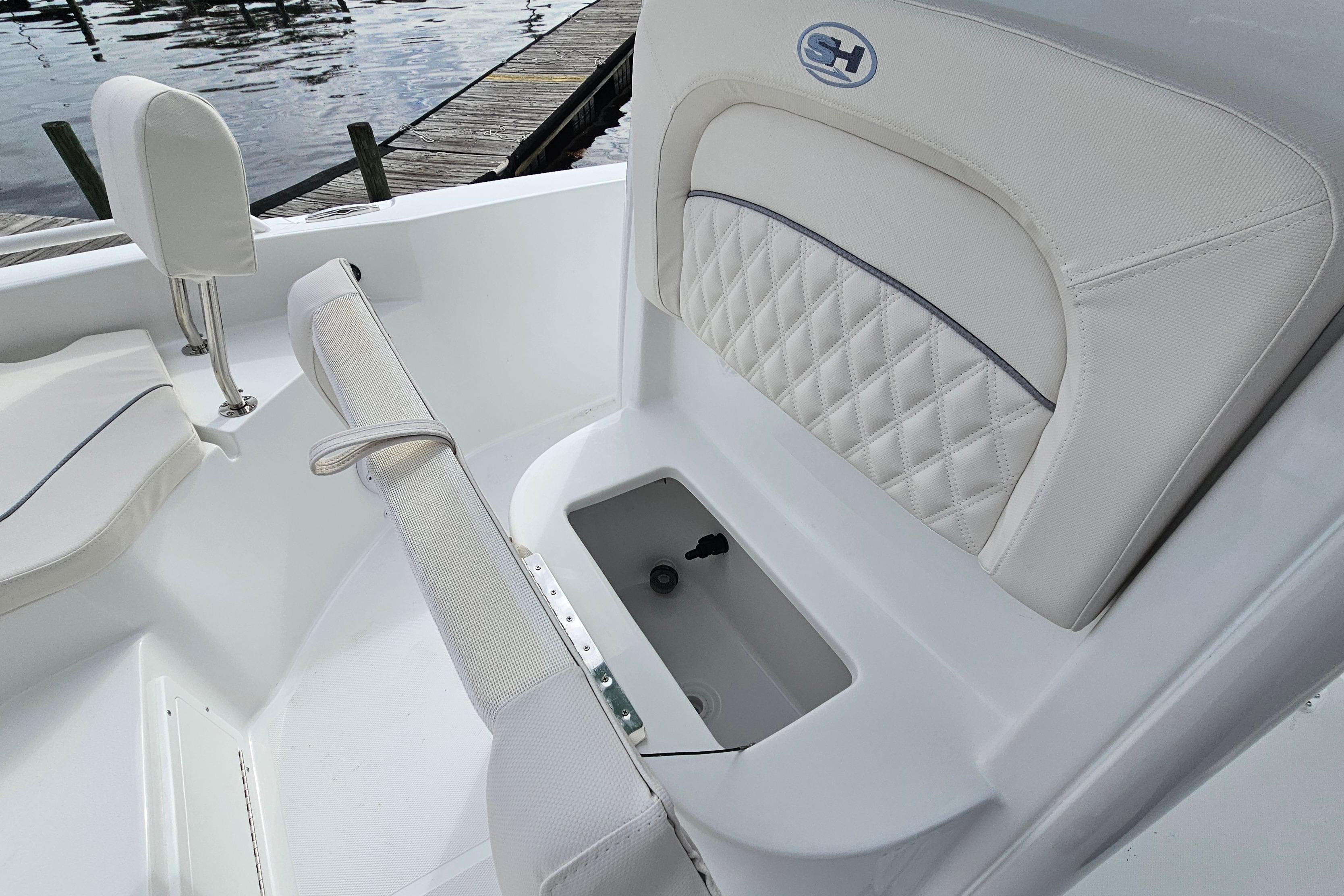 2026 Sea Hunt BX 25 FS boat interior with cushioned seating and storage compartment.