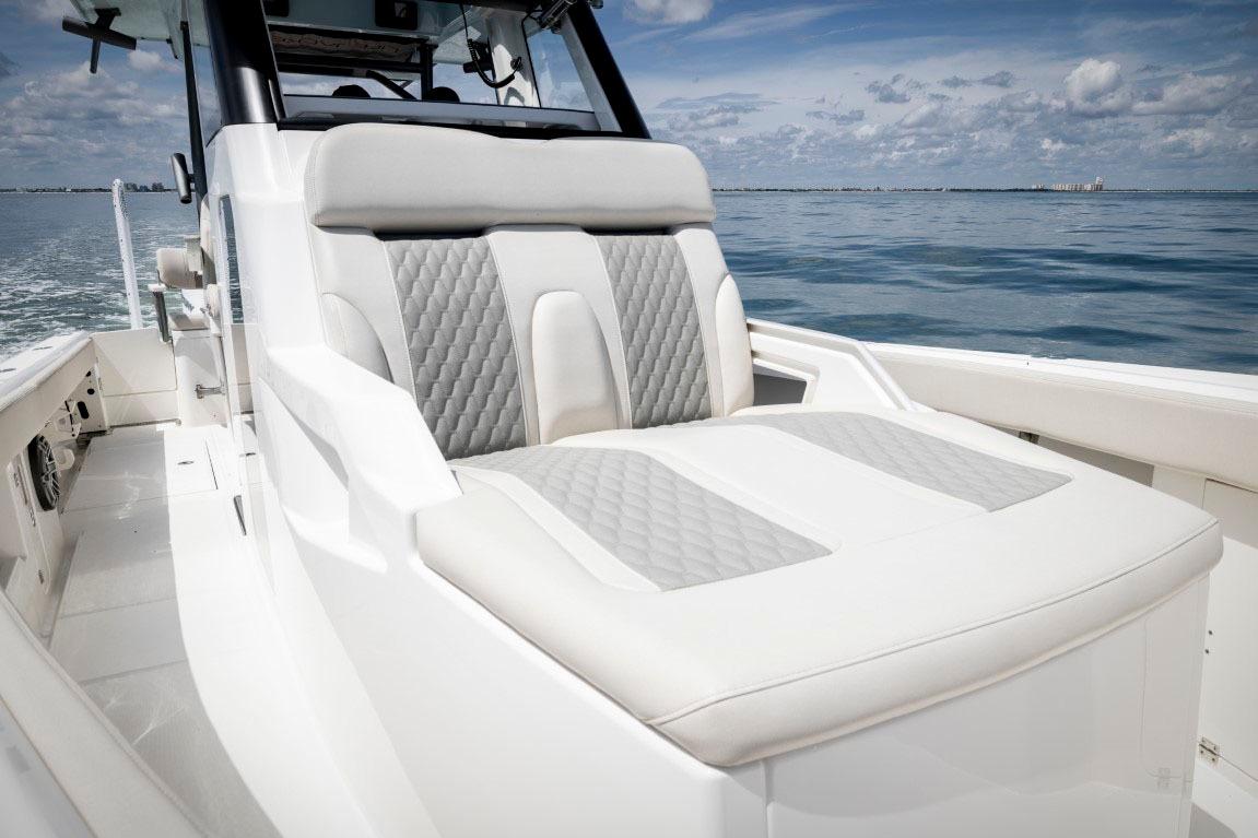 Manufacturer Provided Image: 2026 Solace 30 HCS boat interior with luxurious seating on calm ocean.