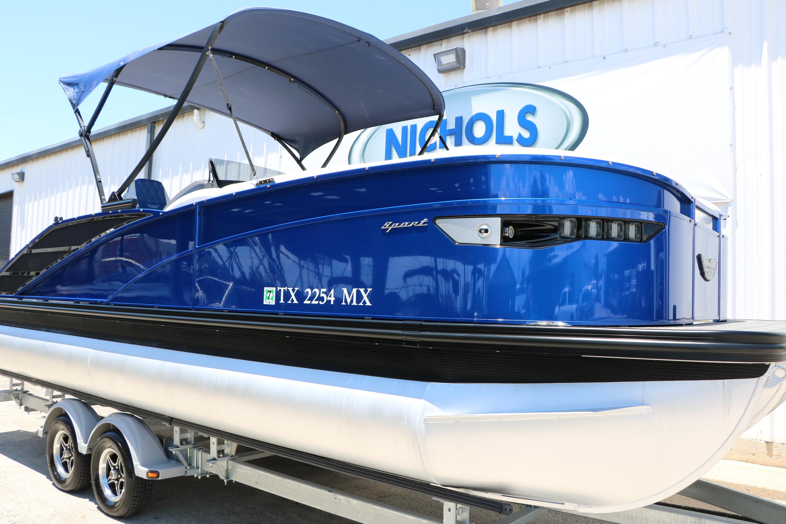 2024 Bennington 23 RX Swingback pontoon boat with blue exterior on a trailer.