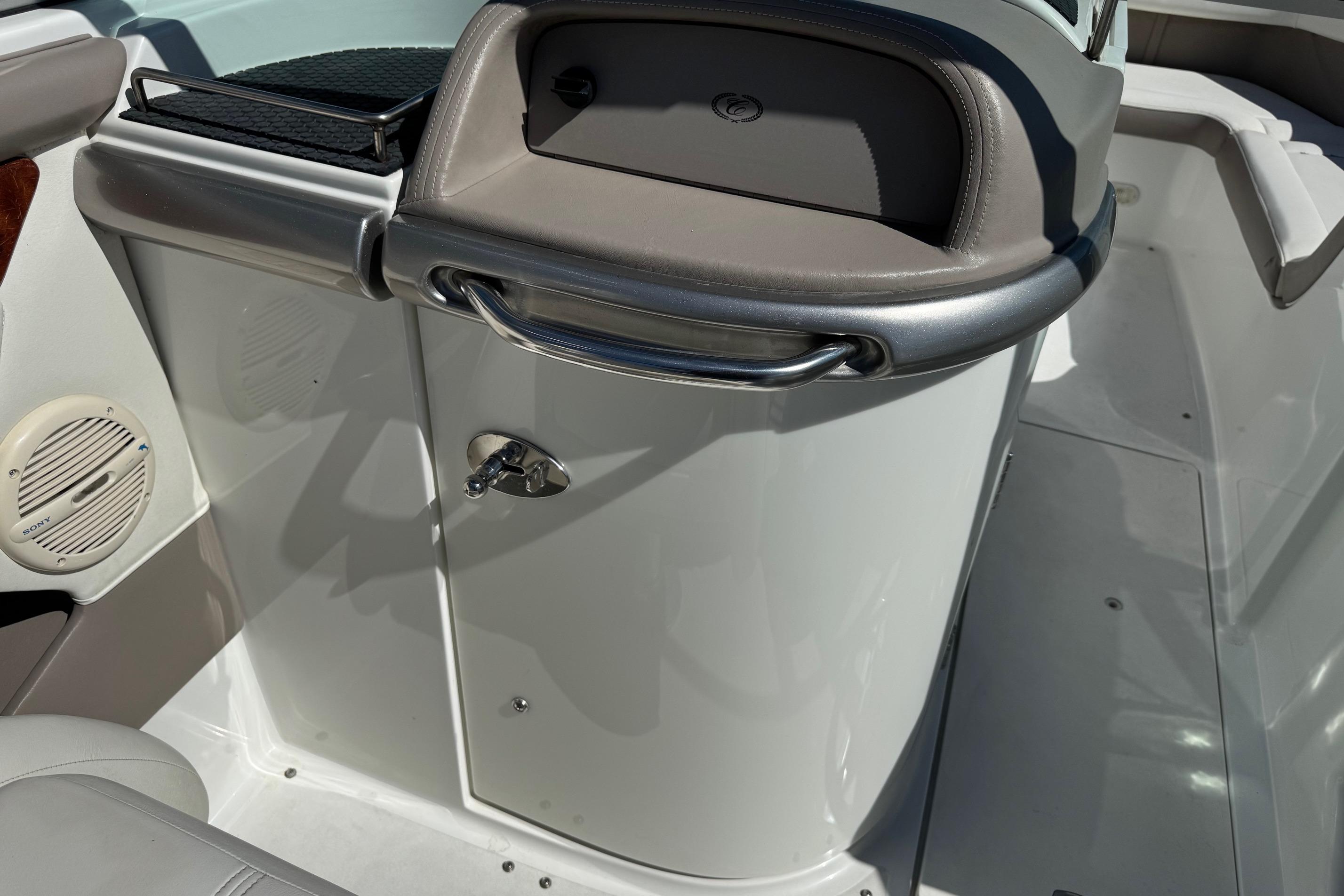 Interior of a 2005 Cobalt 240 boat, featuring a storage compartment and speaker.