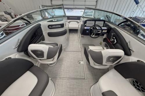2026 Crownline Eclipse E255 boat interior with modern seating and dashboard in a showroom.