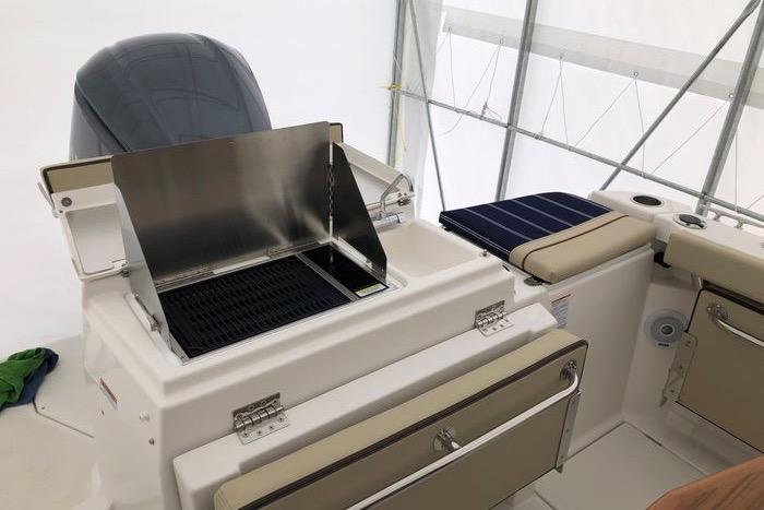 2020 Ranger Tugs R-27 boat interior with built-in grill and seating area.