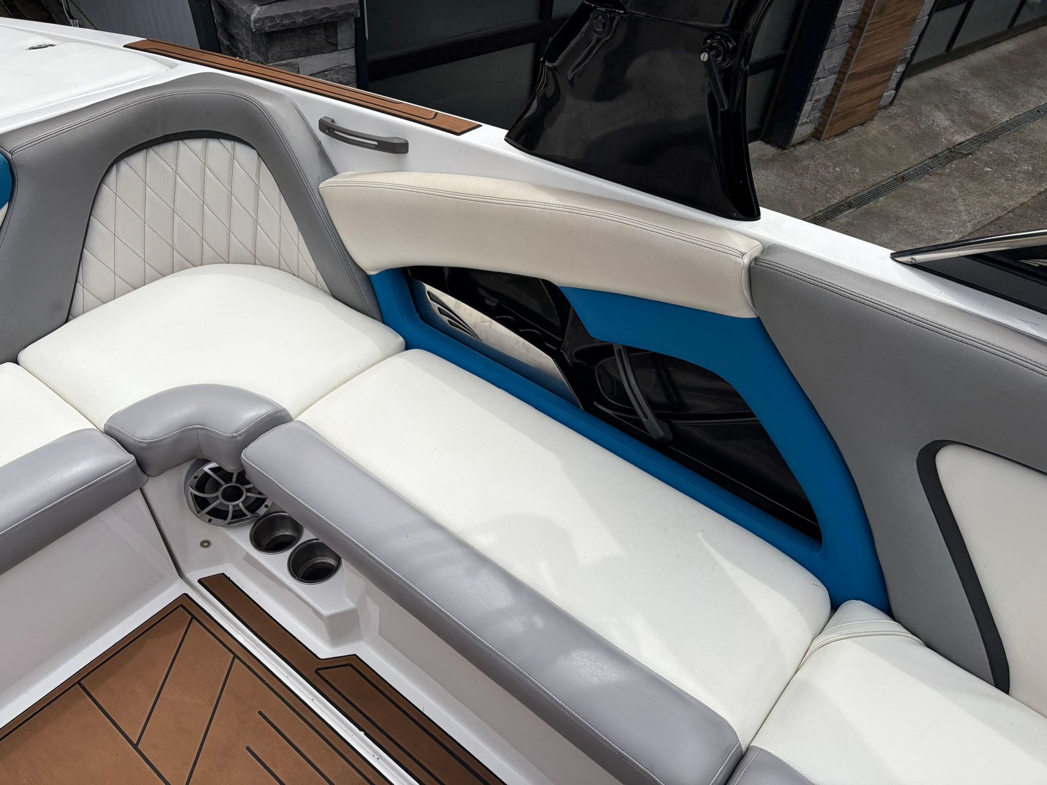 Interior of a 2016 Tigé RZ2 with white and gray seating and blue accents.