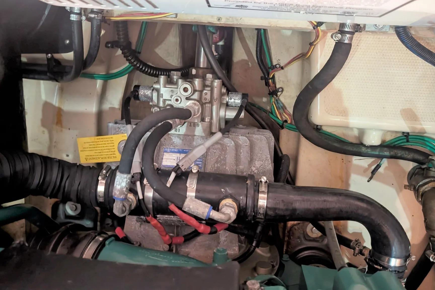 Engine compartment of a 2015 Ranger Tugs R-29 S, showcasing hoses and wiring.