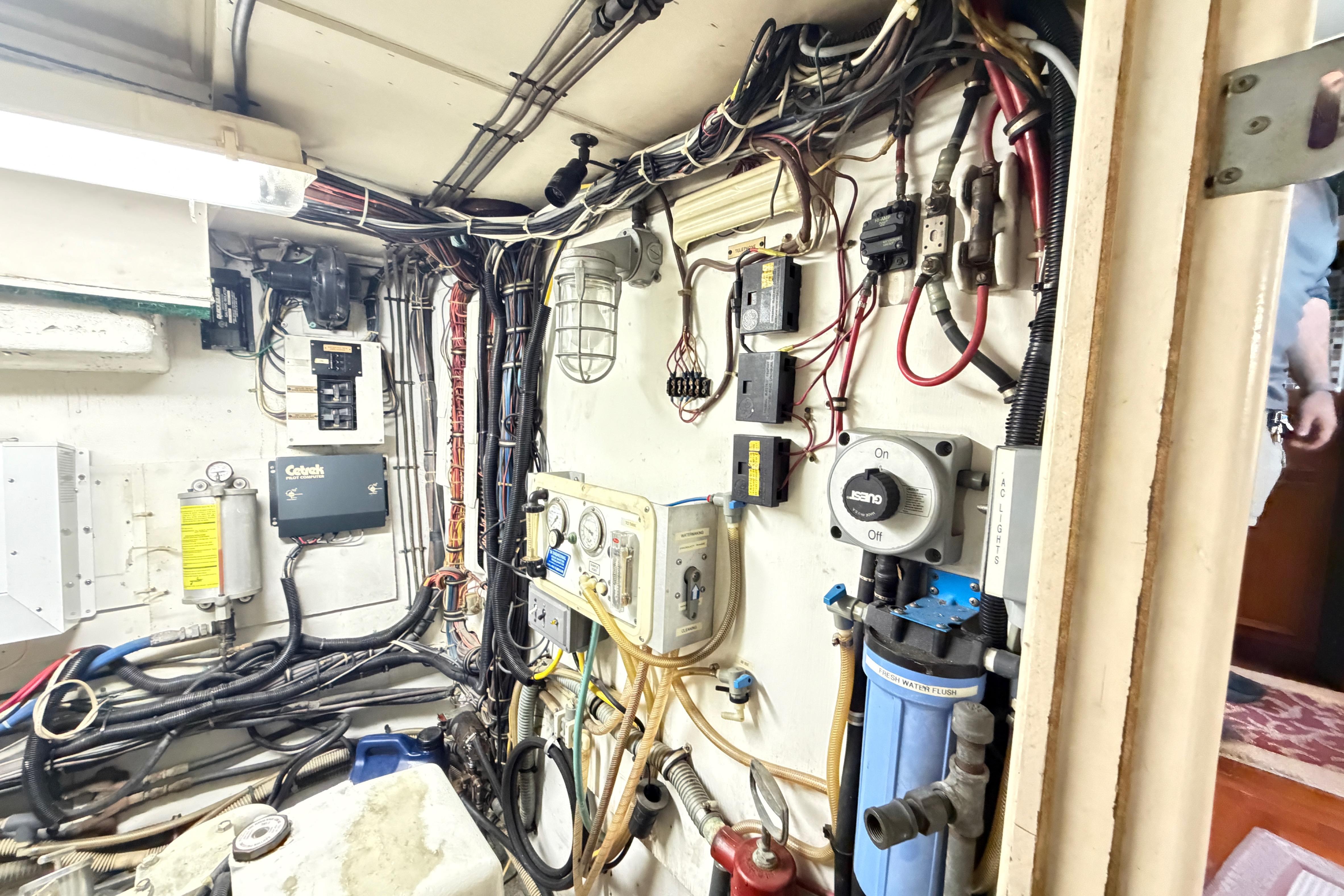 Electrical and mechanical systems inside a 1978 Hatteras 53 Motor Yacht engine room.