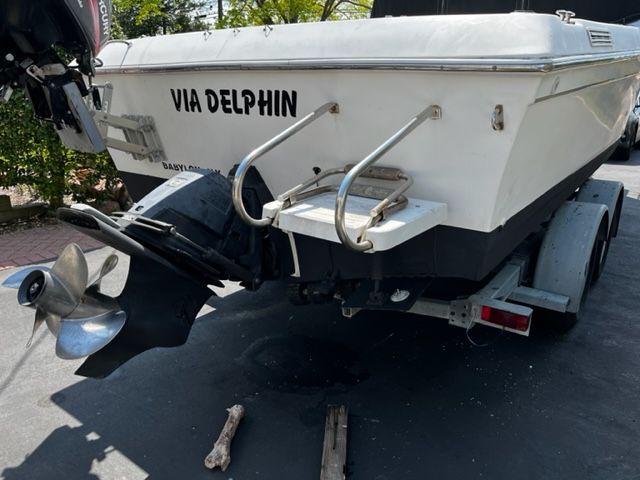 Rear view of a 1998 Sport-Craft 252 Sport Fish boat on a trailer.