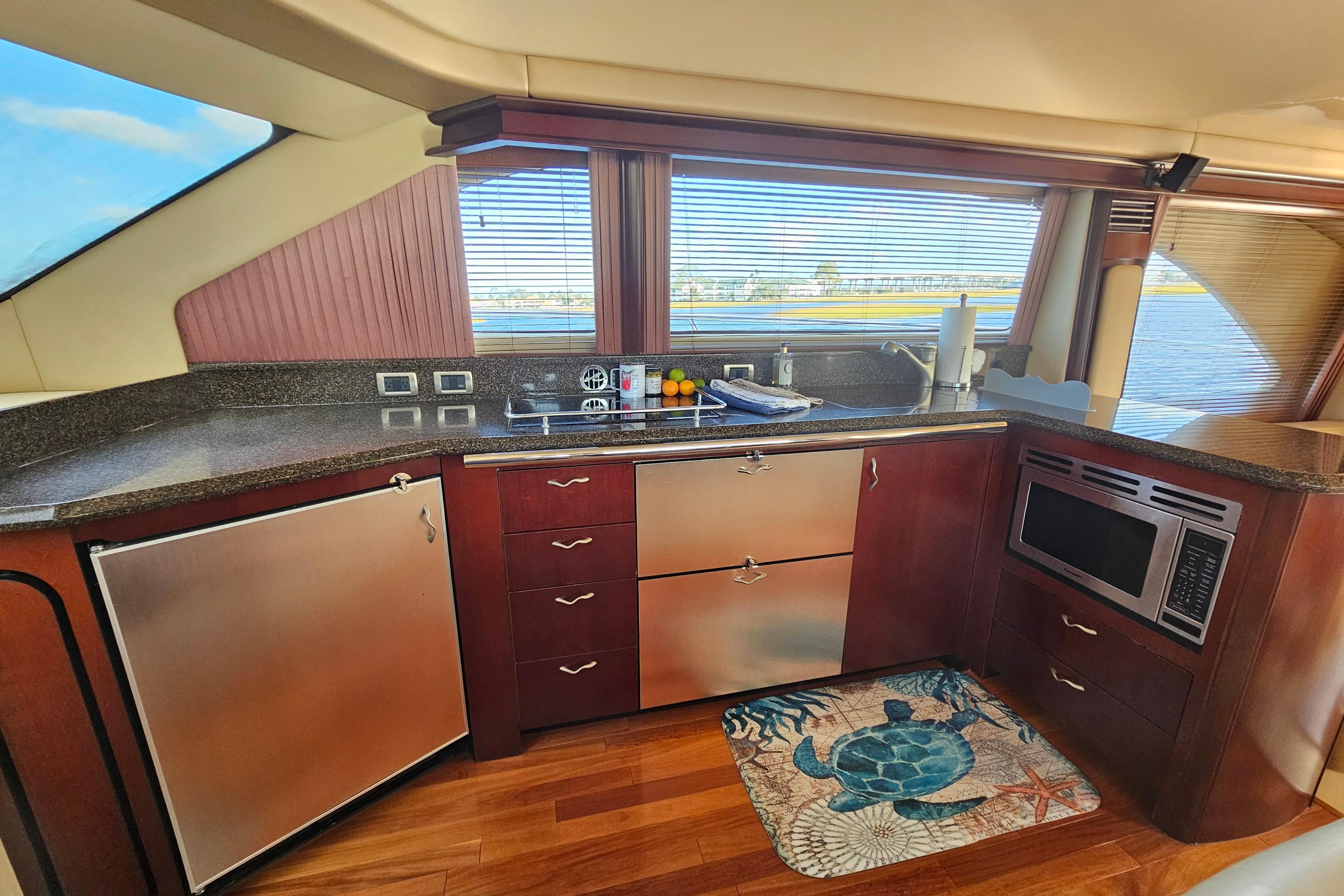 Luxurious kitchen interior of 2006 Sea Ray 580 Sedan Bridge yacht with modern appliances.