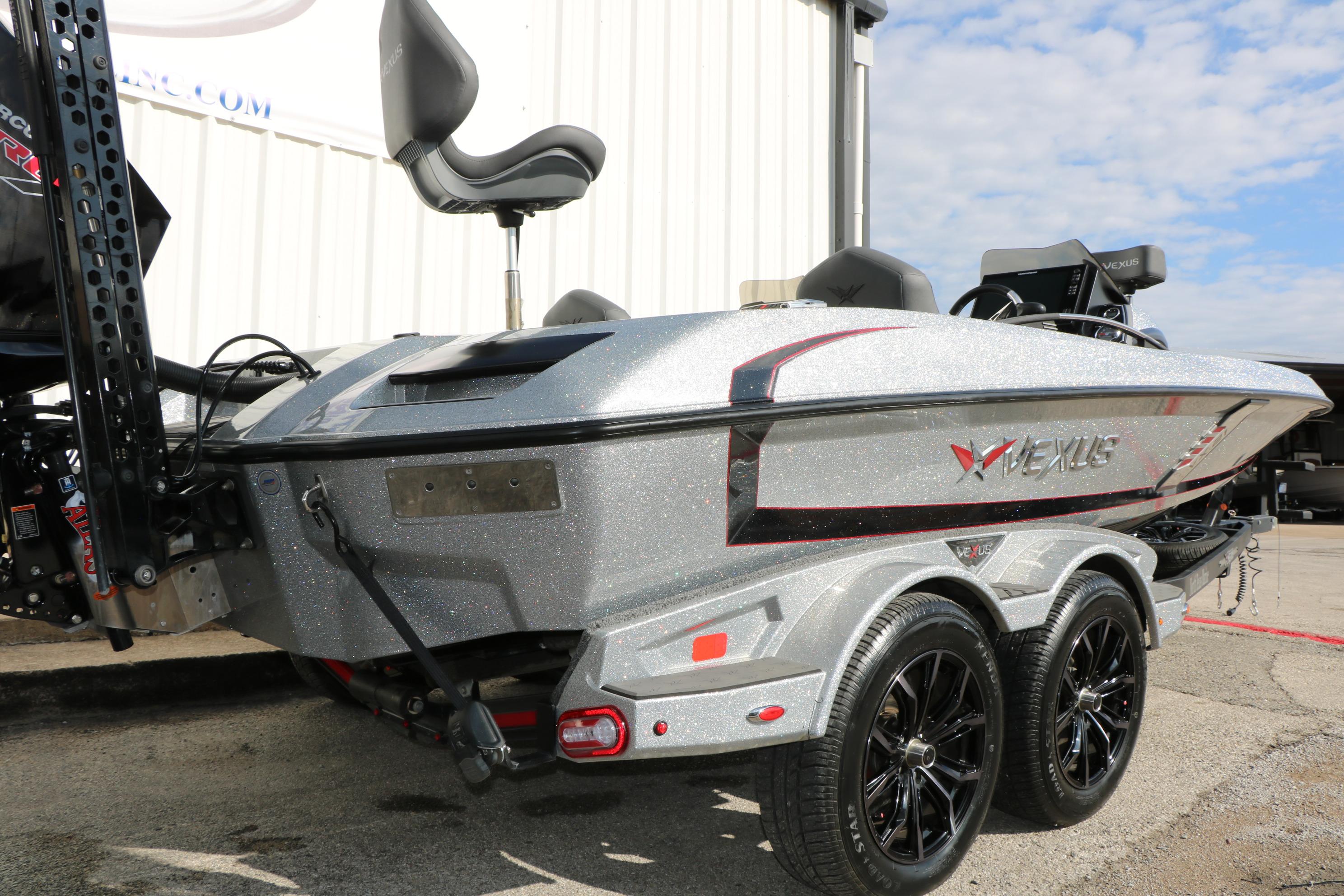 2022 Vexus VX21 boat with sleek design and dual-axle trailer, parked outdoors.