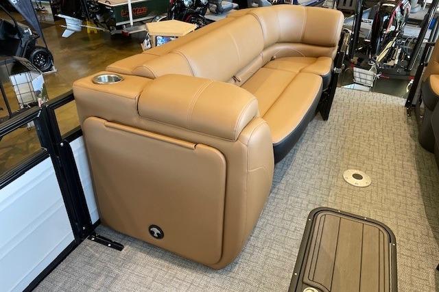 Luxurious tan seating on 2026 Regency 230 DL boat, featuring cup holder and modern design.