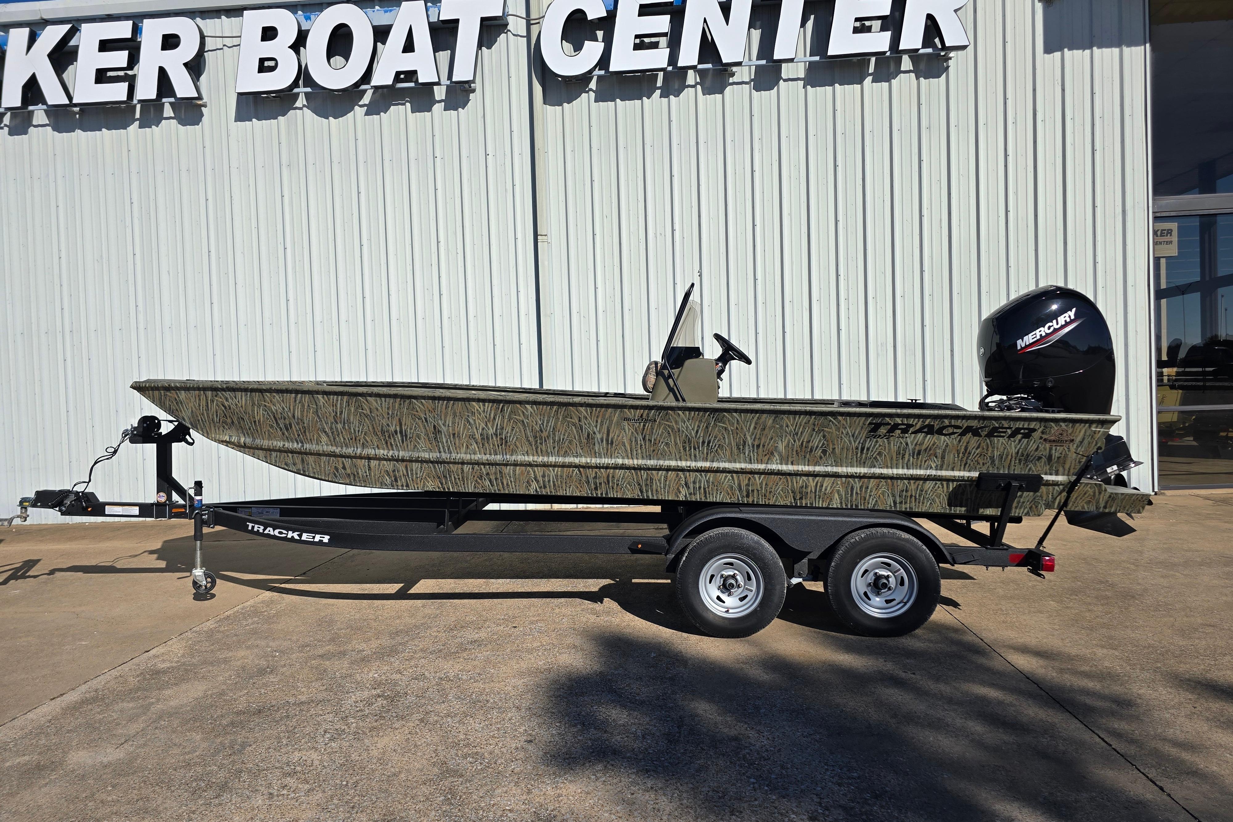 2026 Tracker Grizzly 2072 CC boat on trailer outside dealership.