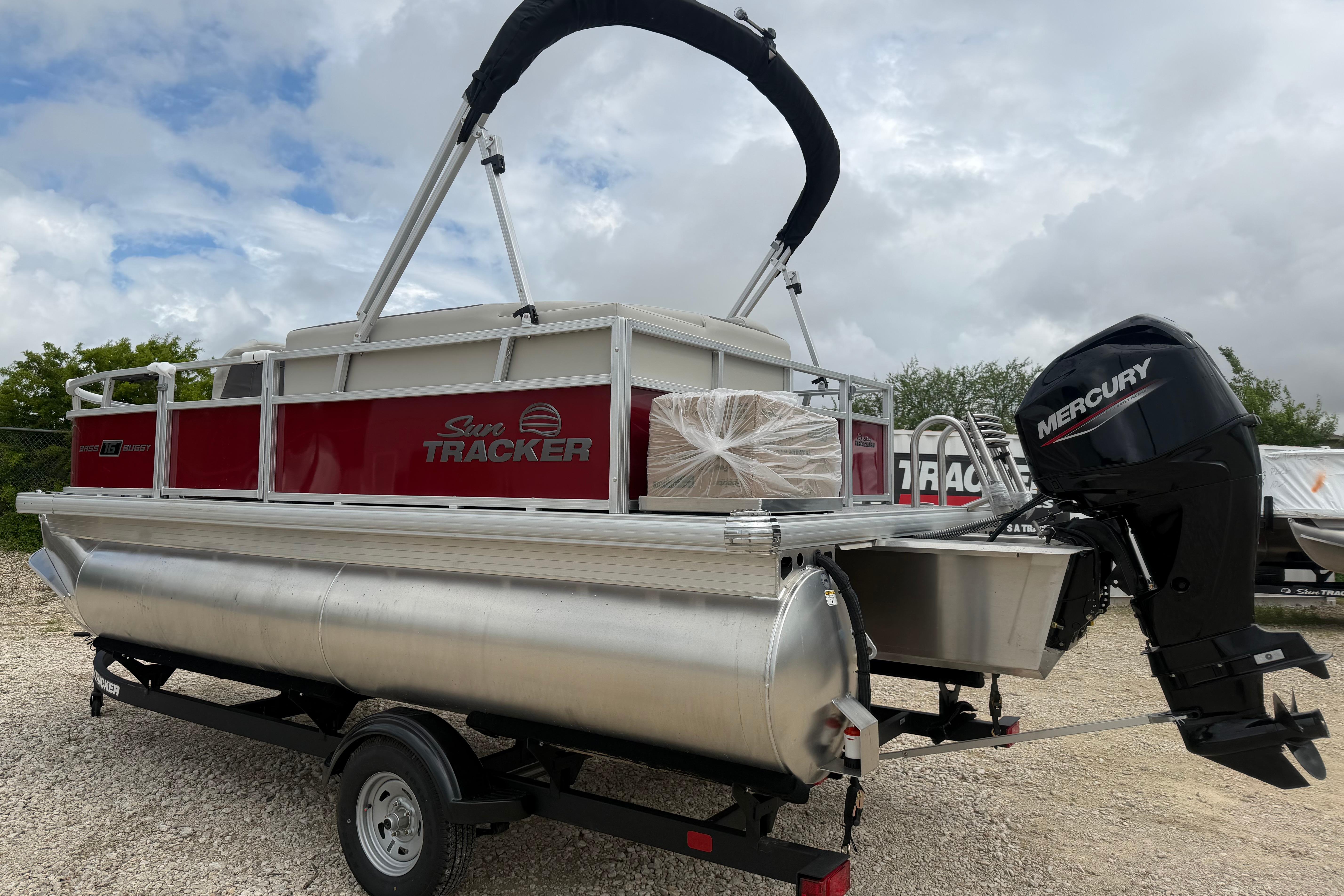 2026 Sun Tracker Bass Buggy 16 XL Select pontoon boat with Mercury outboard motor.