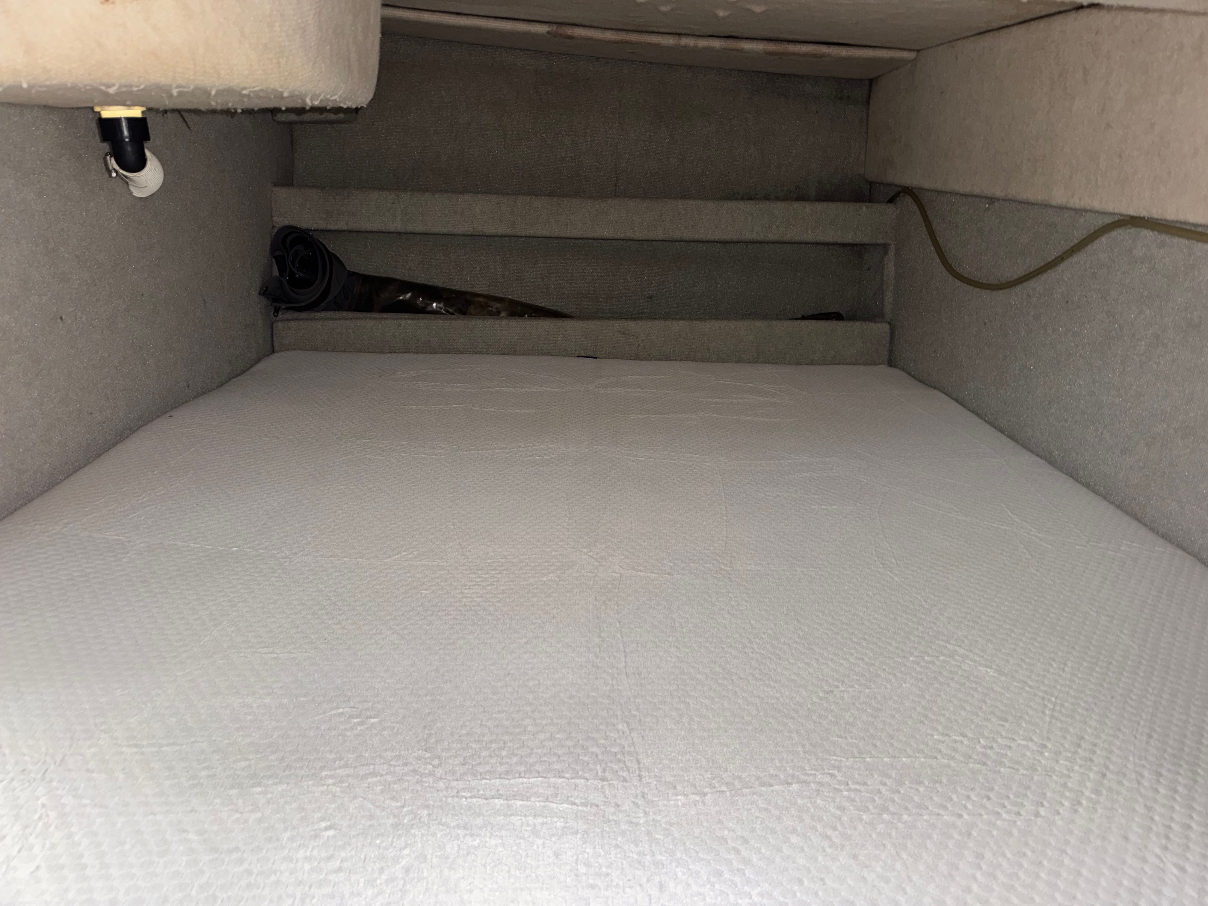Interior of a 1994 Bayliner Ciera with gray carpeted flooring.