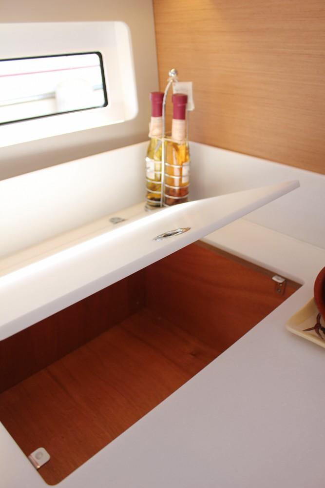 2024 Jeanneau Sun Odyssey 490 interior with open storage compartment and window.