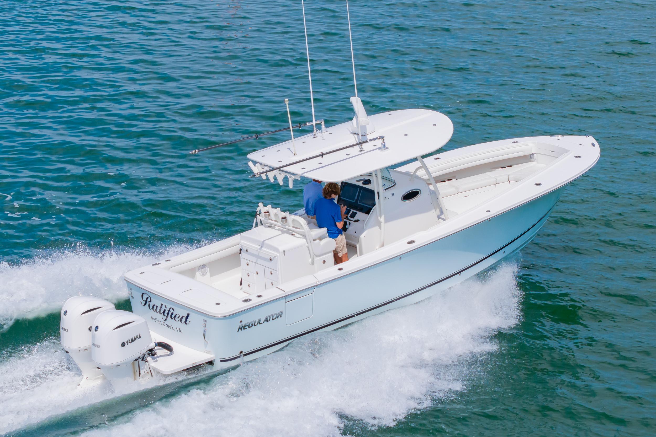 2019 Regulator 31 boat cruising on open water with twin Yamaha engines.