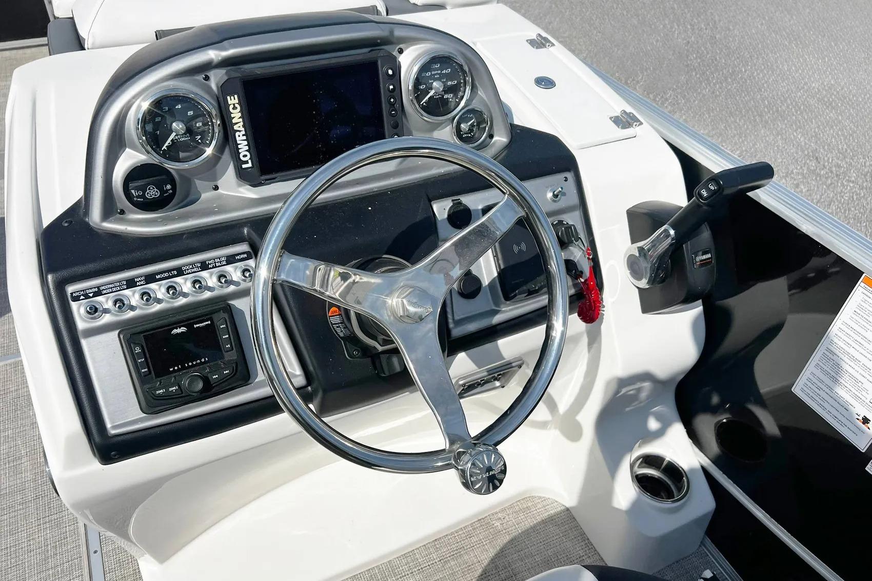 2023 South Bay 523 R boat dashboard with steering wheel and control panel.