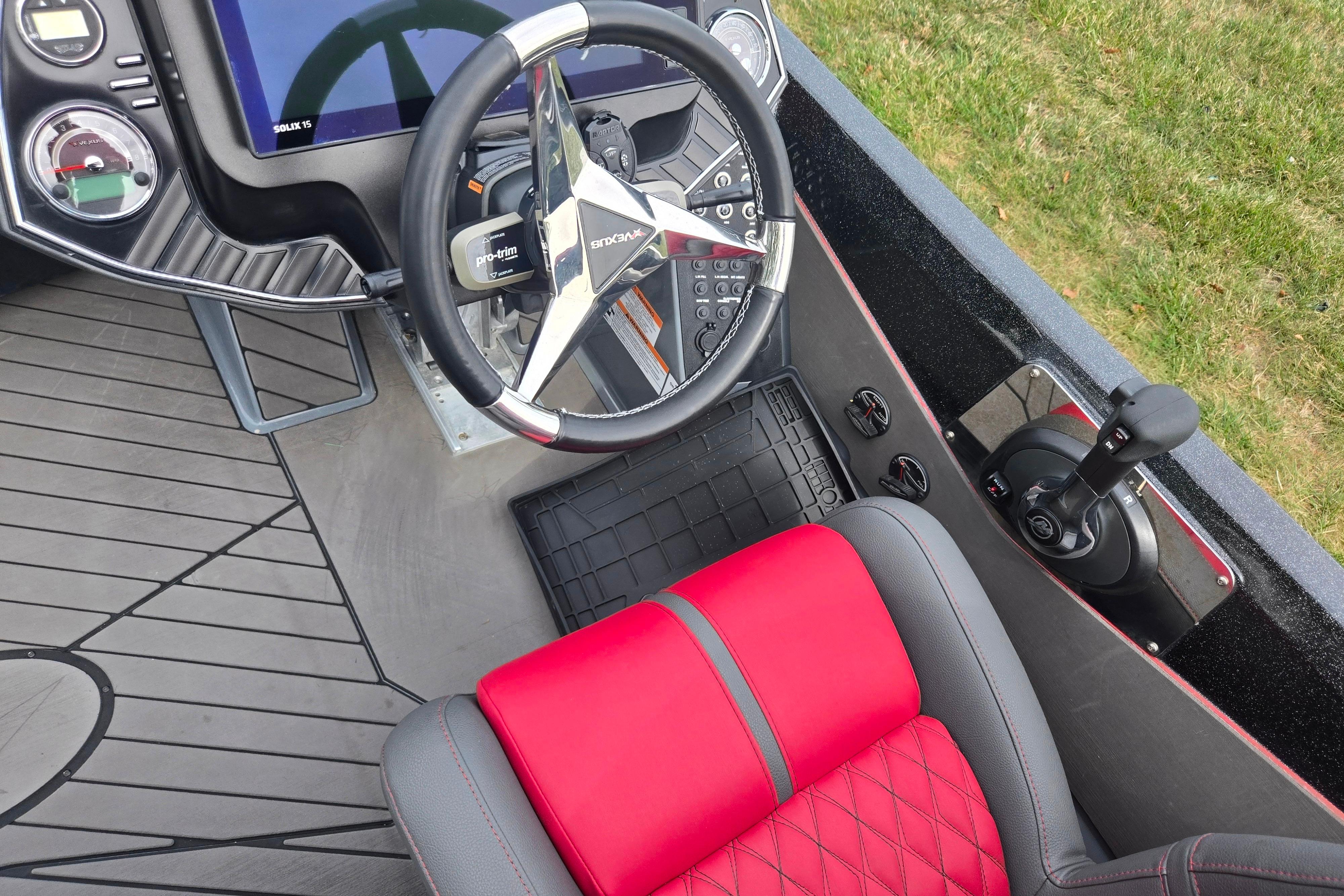 2022 Vexus VX20 boat interior with steering wheel and red seat.