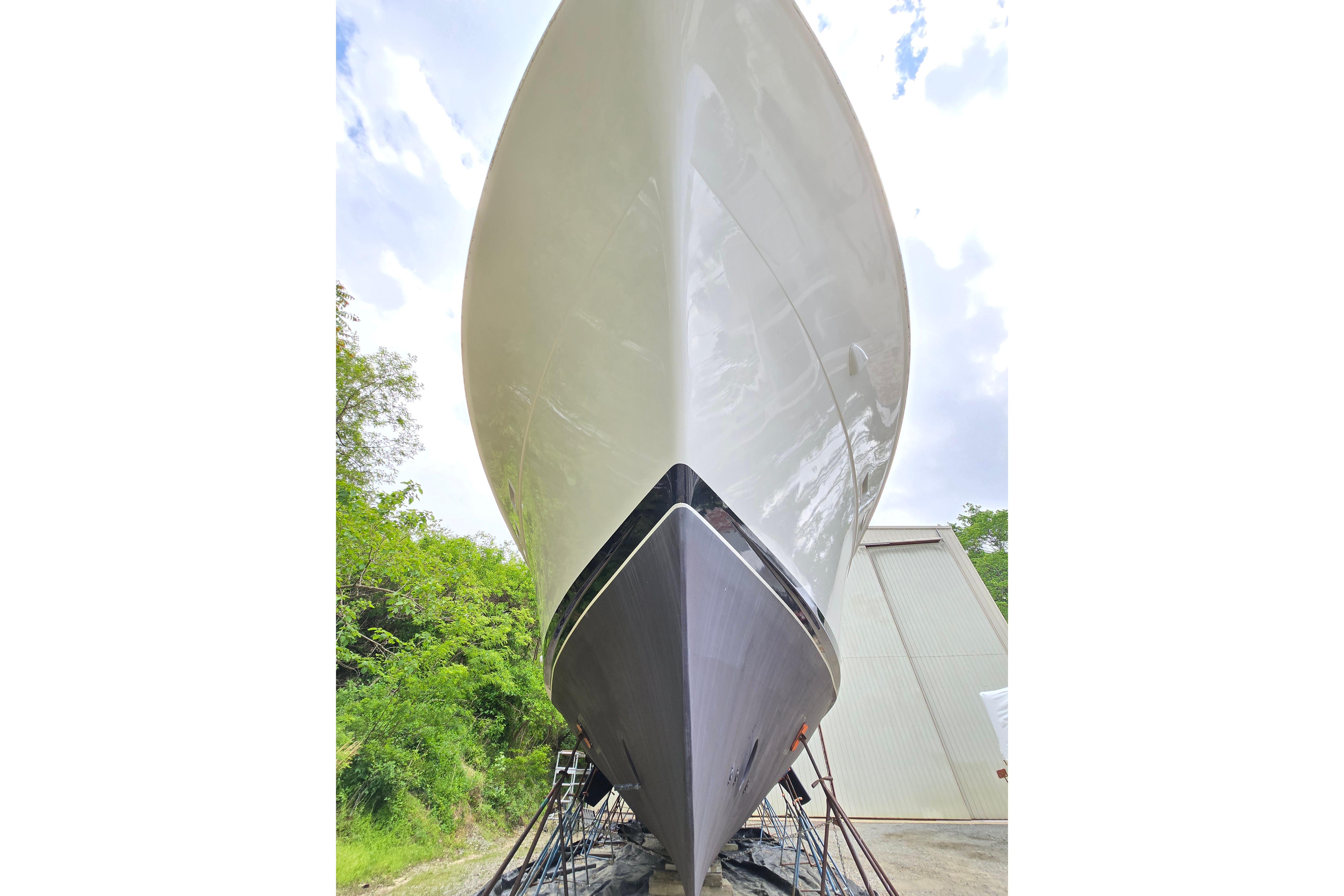 1980 Hatteras 70 Motor Yacht on dry dock, showcasing sleek hull design.