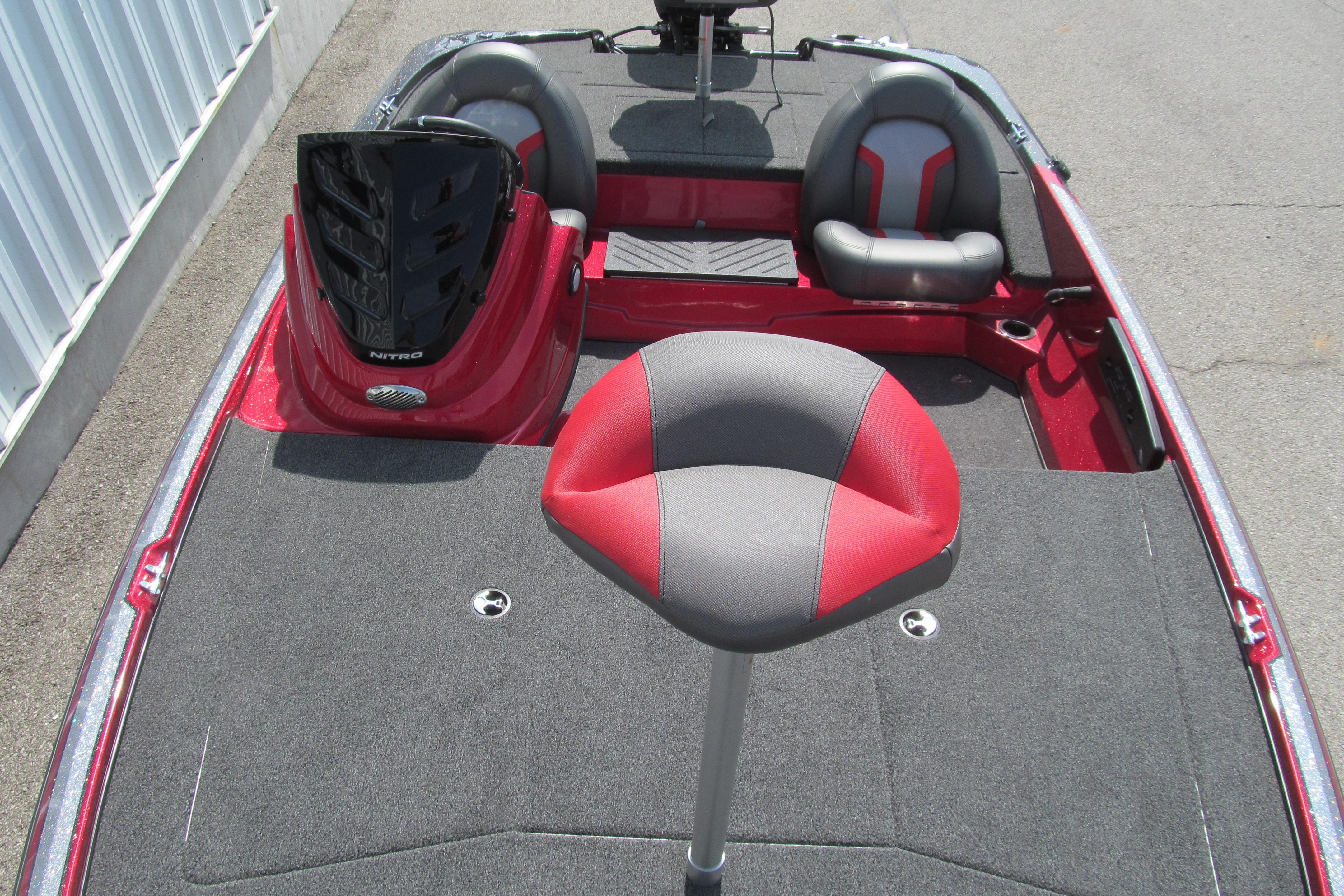 2026 Nitro Z17 boat interior with red and gray seating, carpeted deck, and steering console.