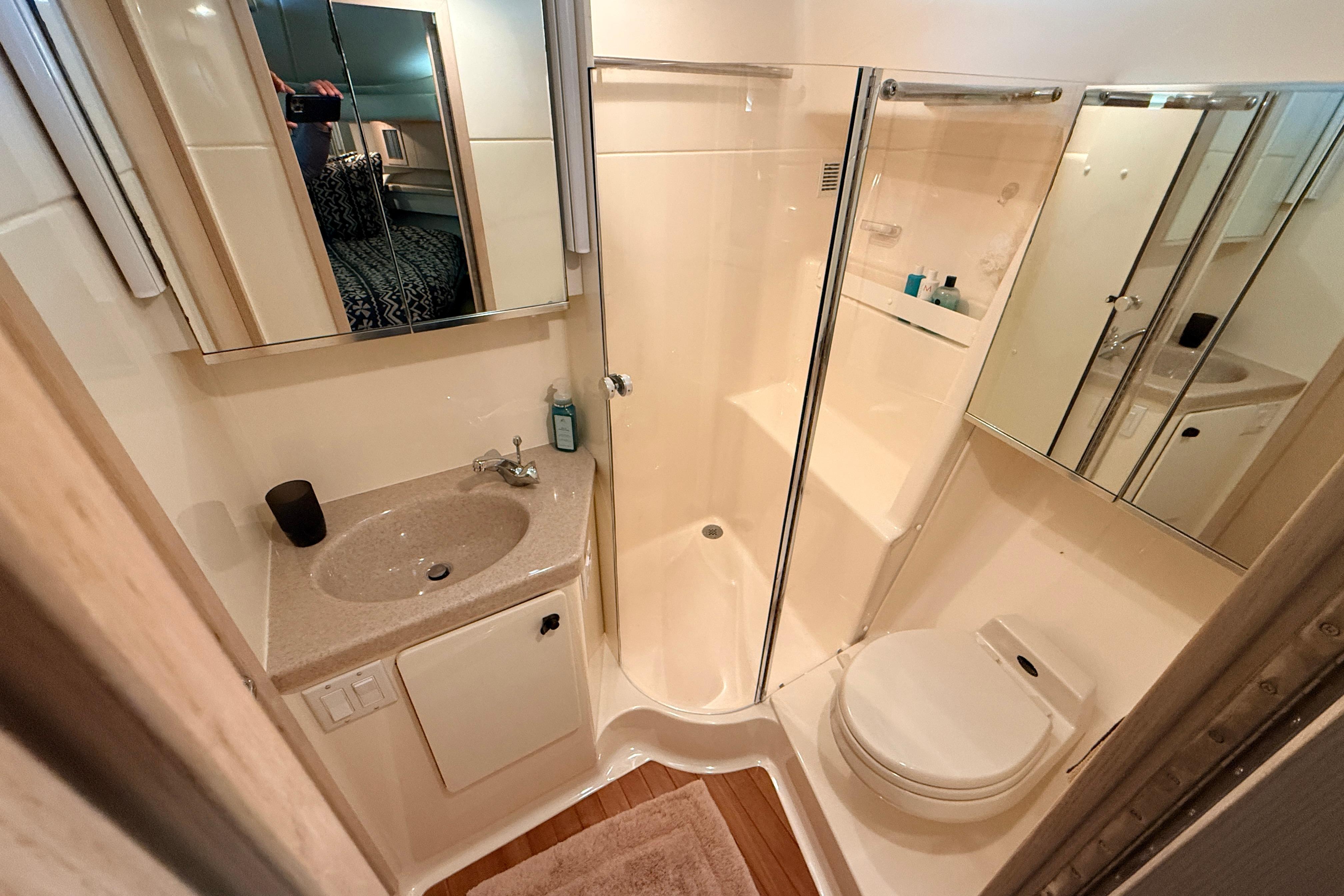 Bathroom interior of 1995 Tiara Yachts 4000 Express, featuring sink, shower, and toilet.