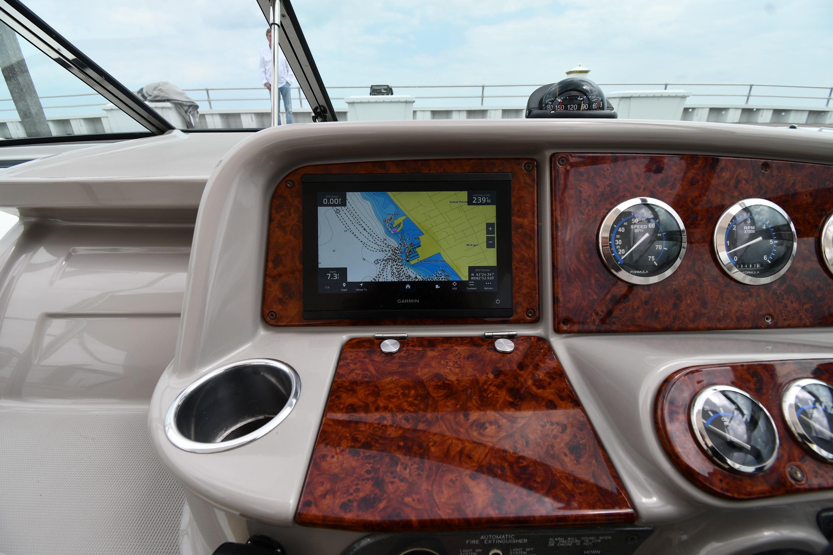 Dashboard of a 2004 Formula 330 Sun Sport boat with navigation display and gauges.