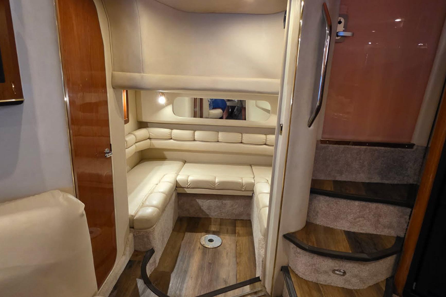 1998 Sea Ray Sundancer 400 interior with beige seating and wooden accents.