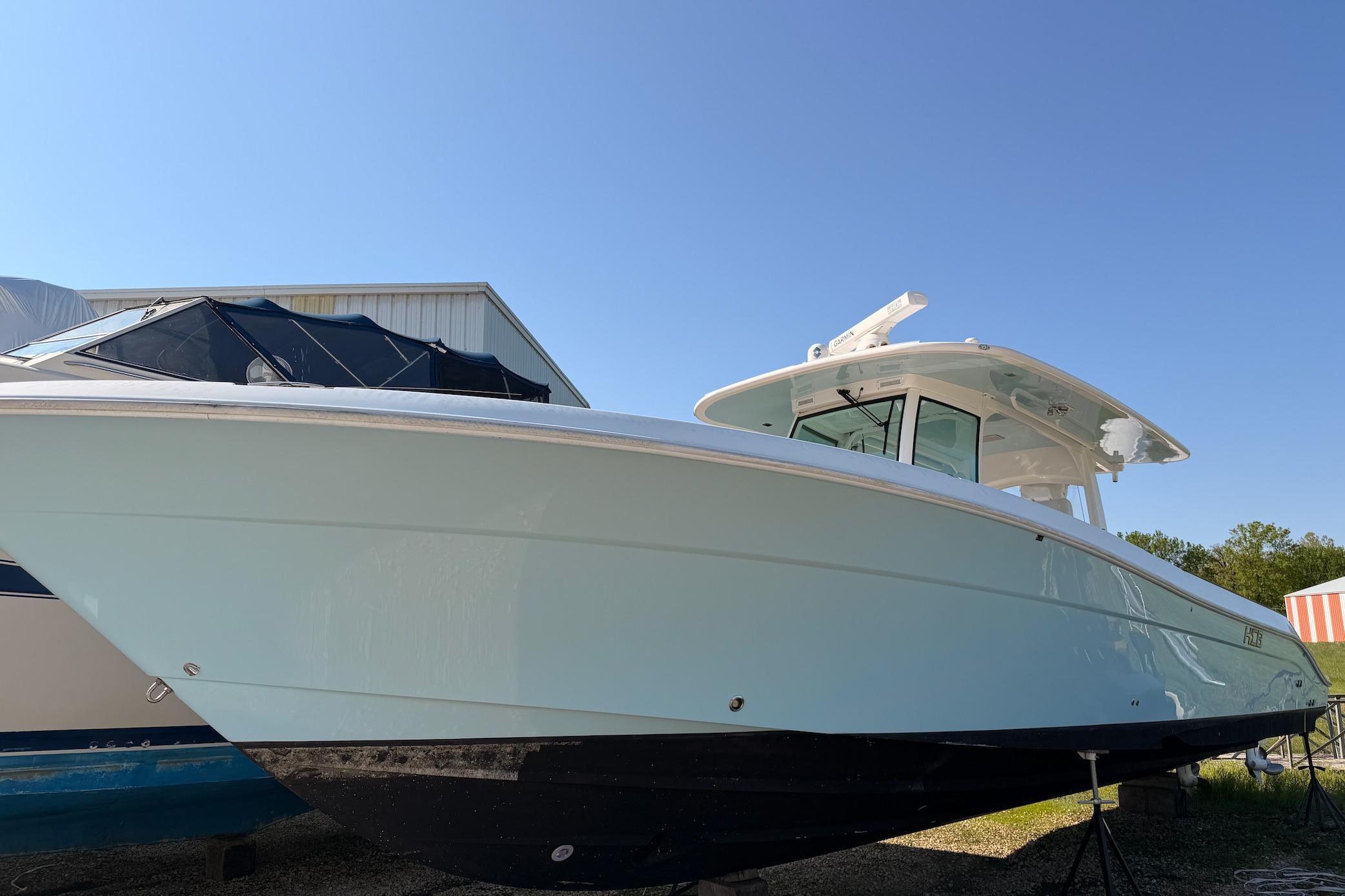 2022 HCB 42 Lujo boat displayed outdoors under clear blue sky.