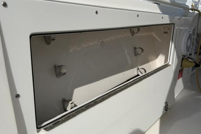 2014 Edgewater 318CC boat storage compartment, open and empty, showcasing interior details.