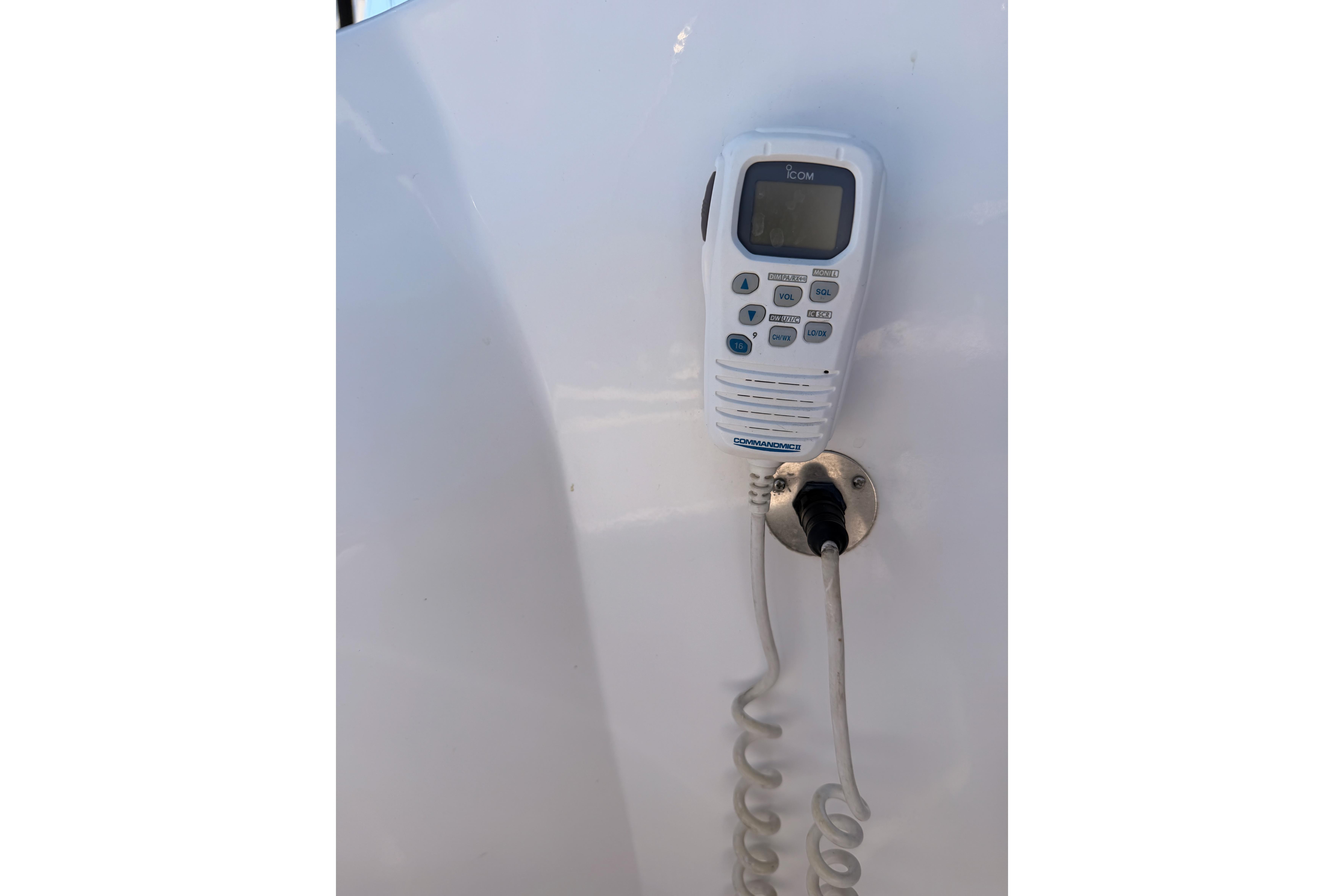 VHF radio handset on 2008 Hunter 45 Deck Salon yacht, mounted on white panel.