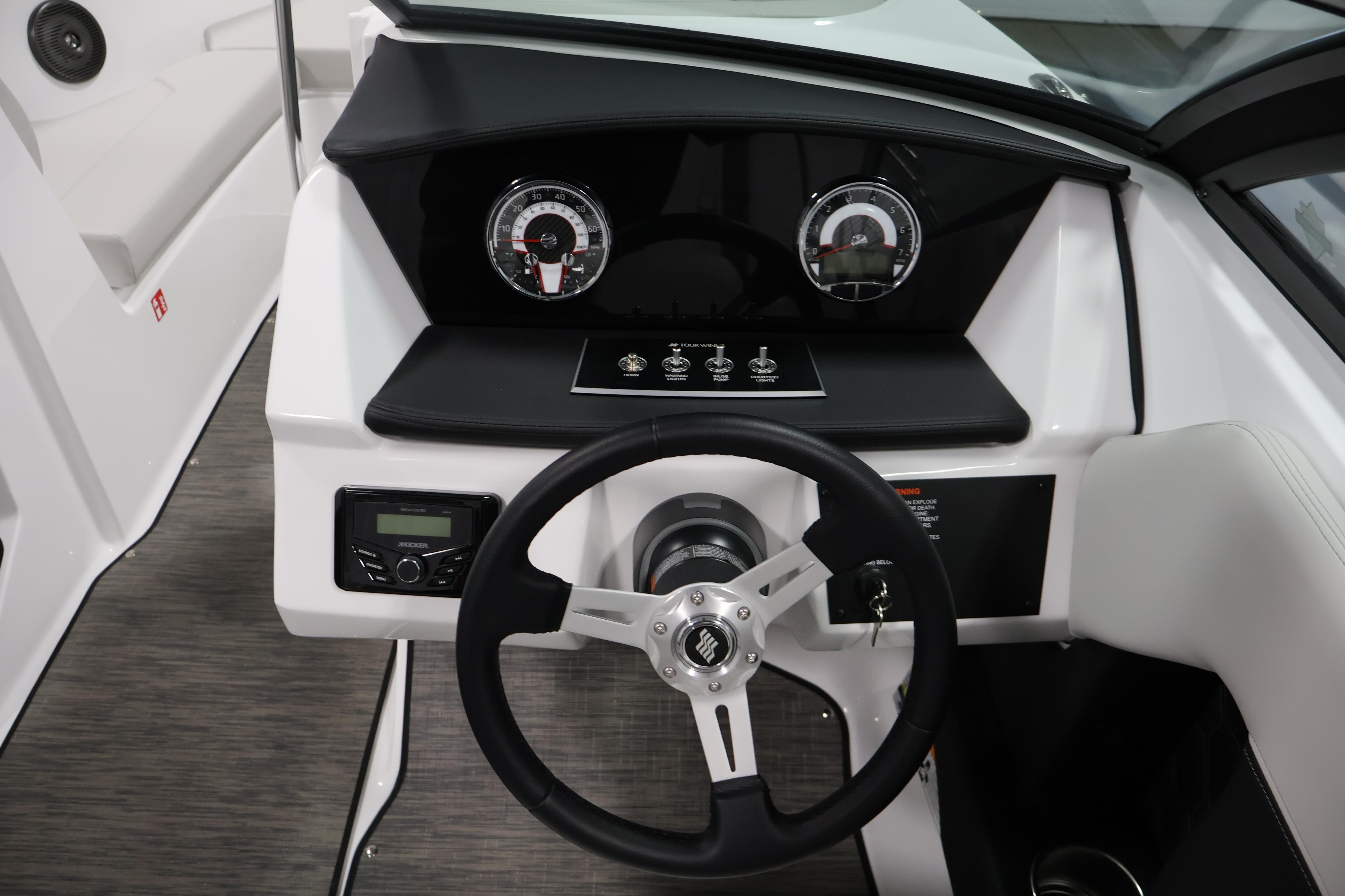 2026 Four Winns H4 Freedom boat dashboard with steering wheel and gauges.