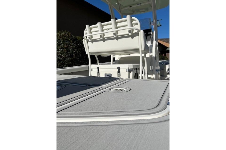 2026 Mako 24 APEX boat interior with seating and storage compartments.