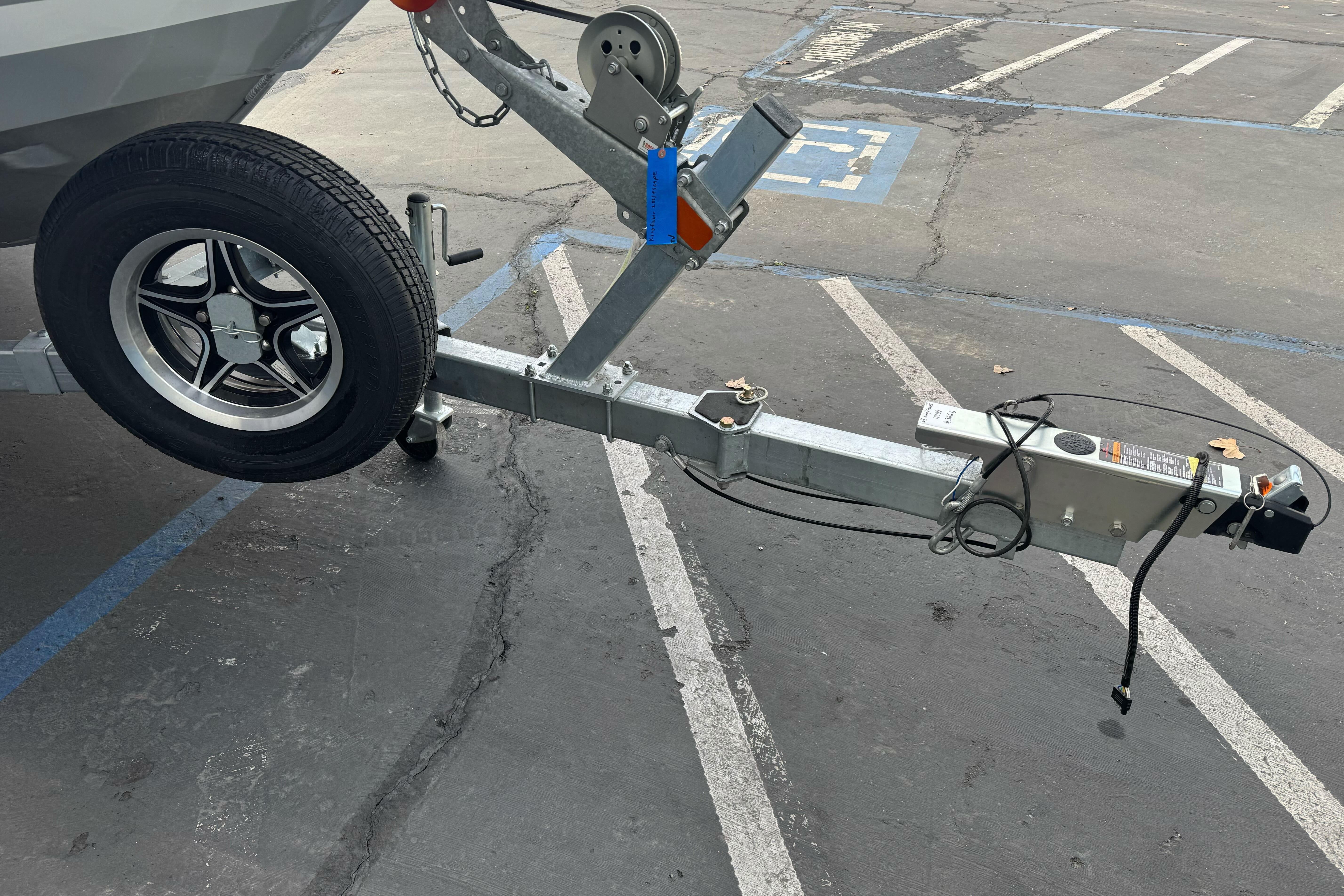 Trailer hitch of 2026 KingFisher 2025 Escape boat in parking lot.