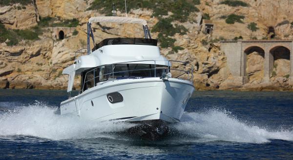 Beneteau Swift Trawler 35, 2021, cruising near rocky coastline.