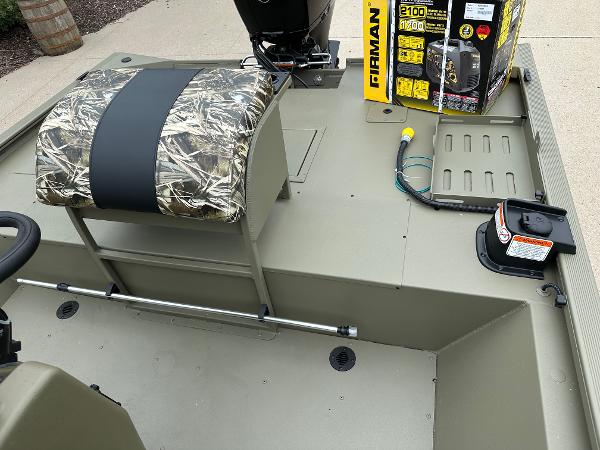 2025 Tracker Grizzly 2072 CC Sportsman boat interior with camo seat and equipment.