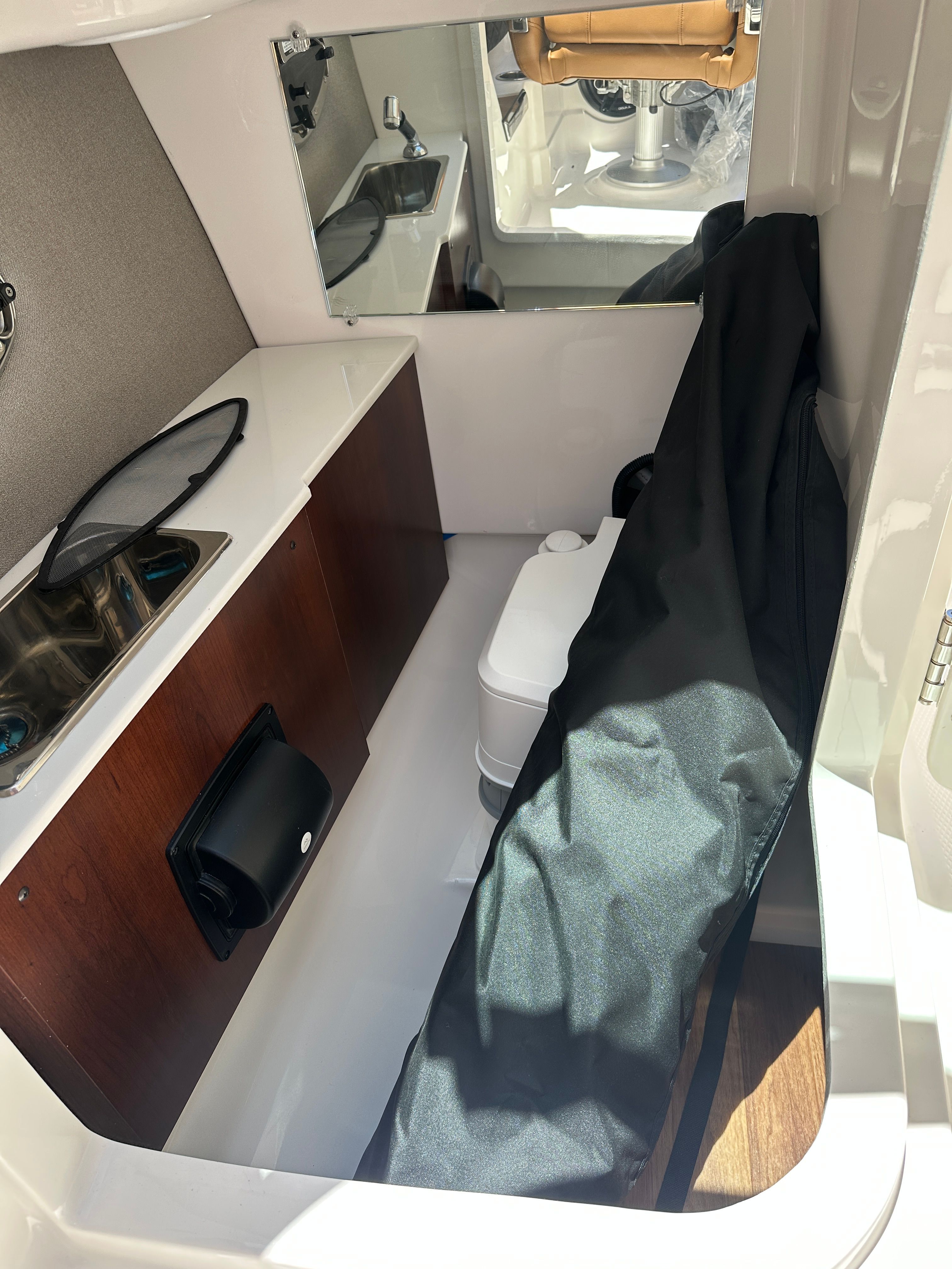 Interior of a 2025 Chaparral 26 Surf with a sink and storage area.