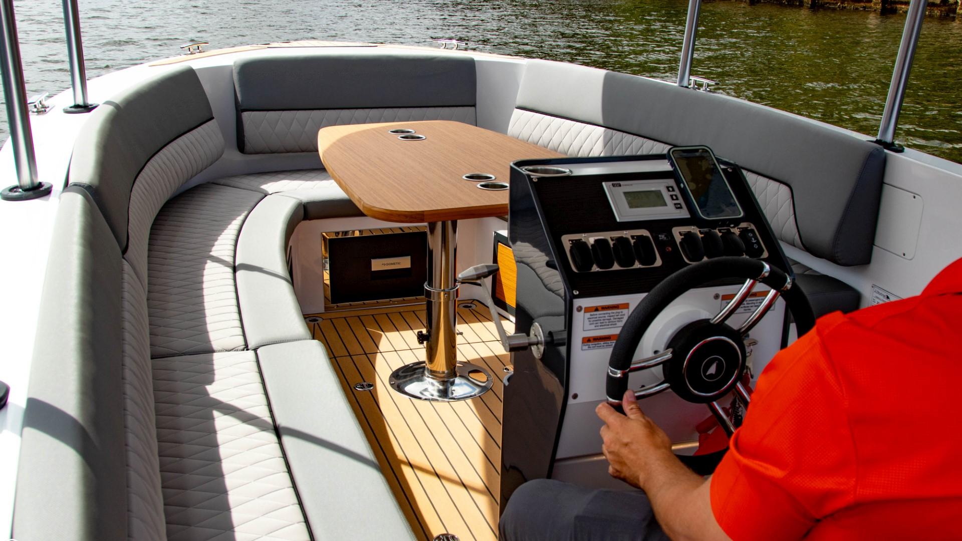 2023 Alfastreet 21 Open boat interior with steering console and seating area.
