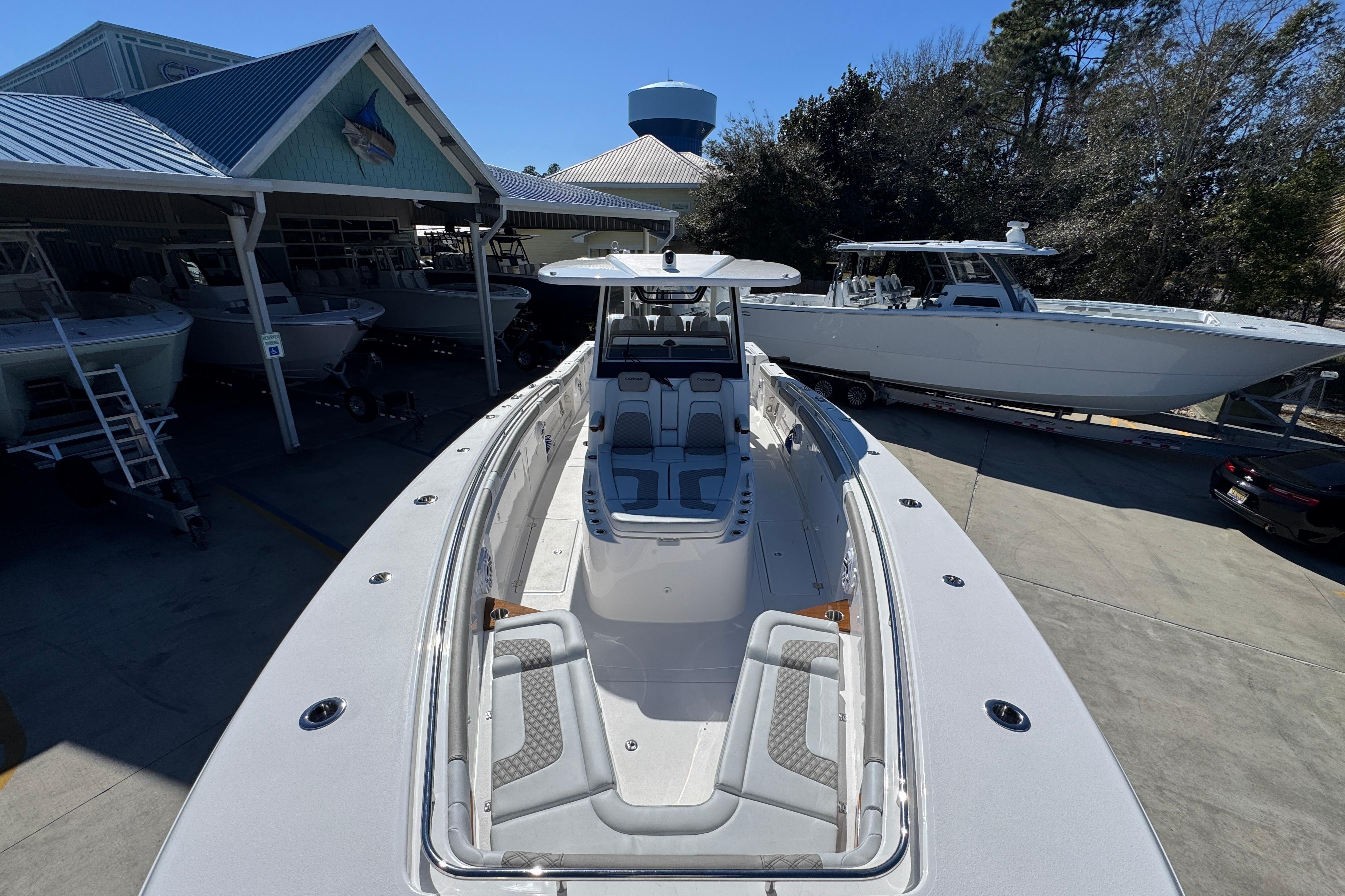 2027 Caymas 401 CC boat displayed at a marina with other vessels.
