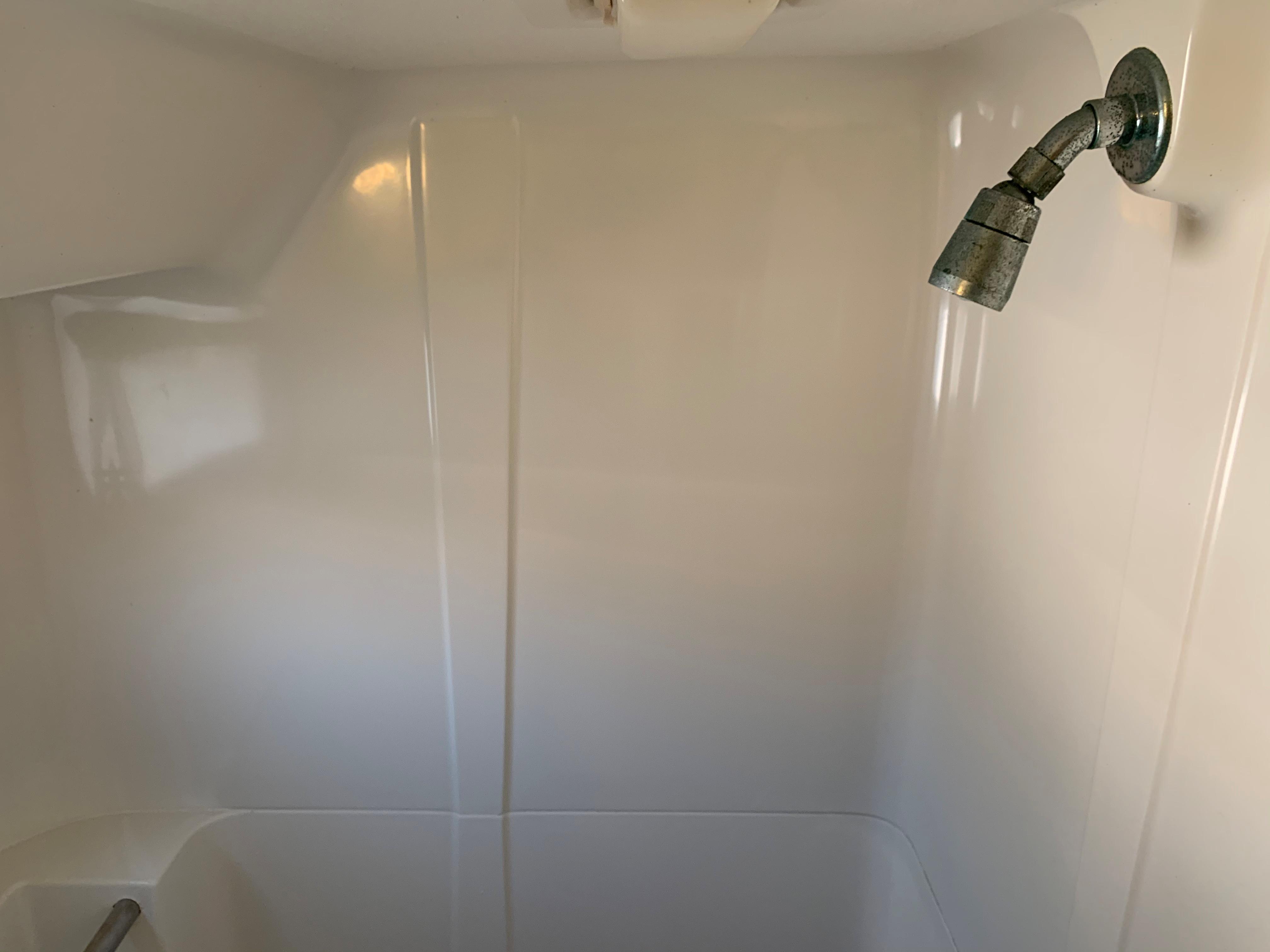 Shower area in 1992 Silverton 34 Aft Cabin Motor Yacht, featuring a simple showerhead.