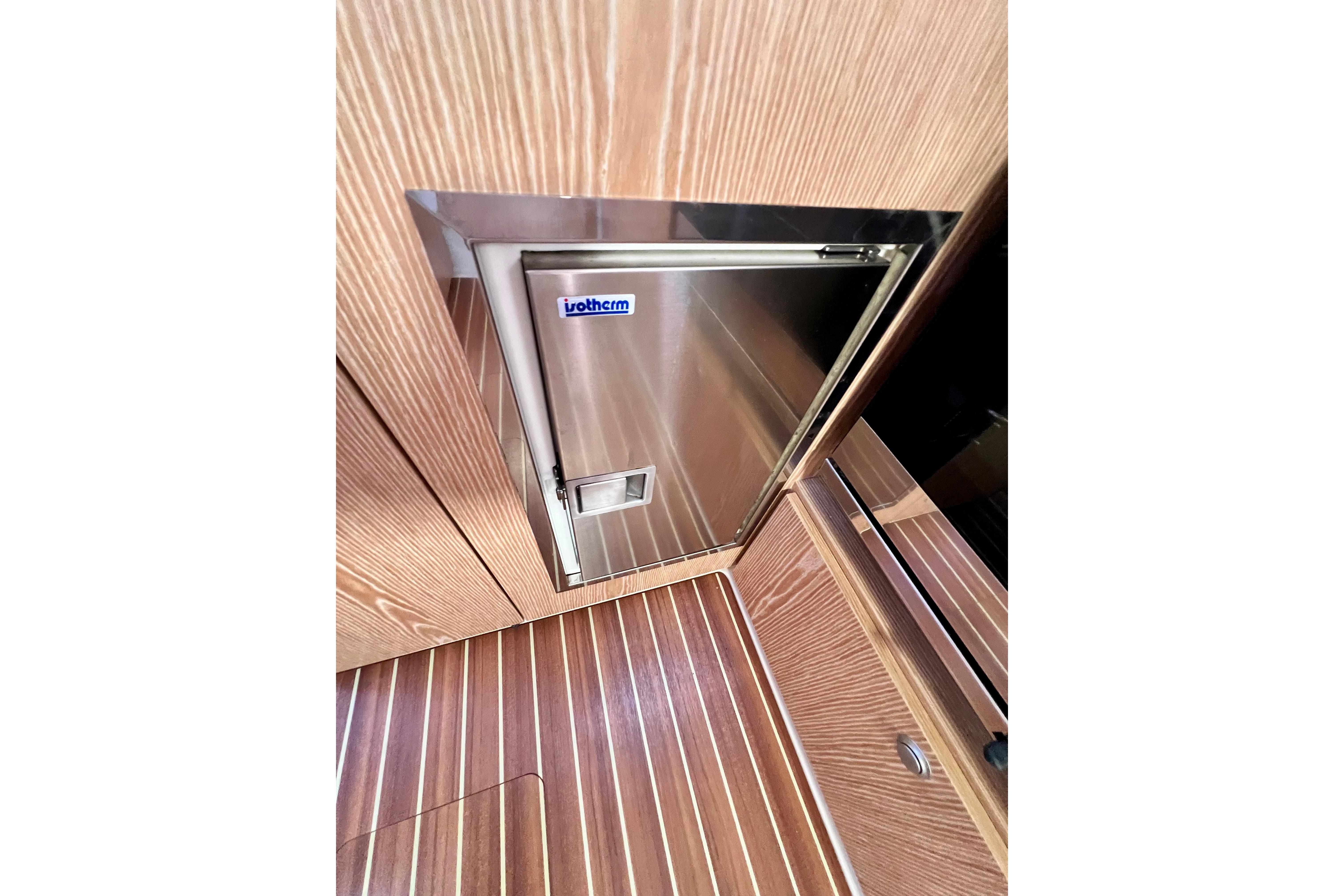 Stainless steel fridge on 2016 Hanse 455 yacht with wood paneling.