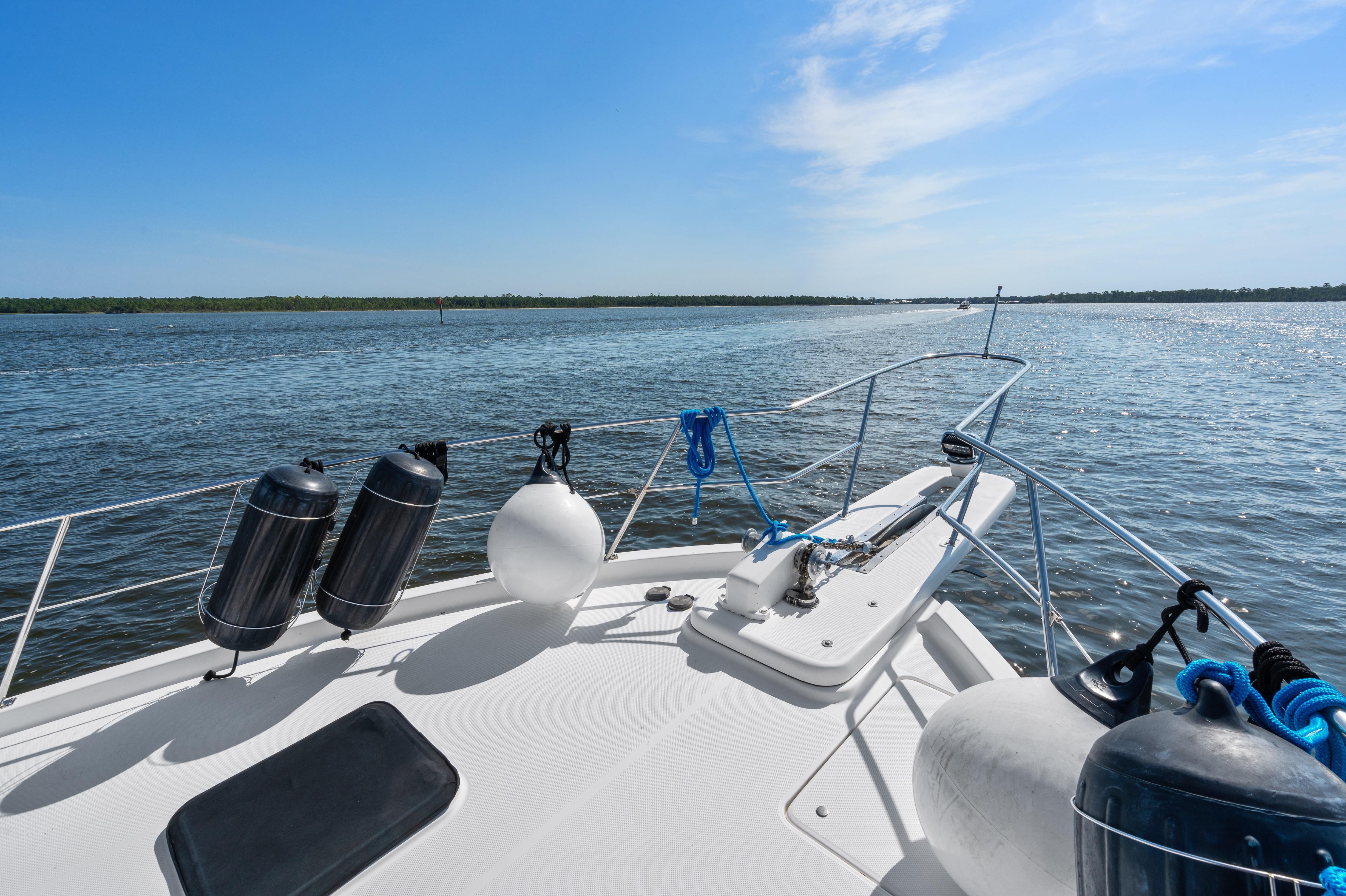 2007 Meridian 490 Pilothouse yacht on open water under clear blue sky.